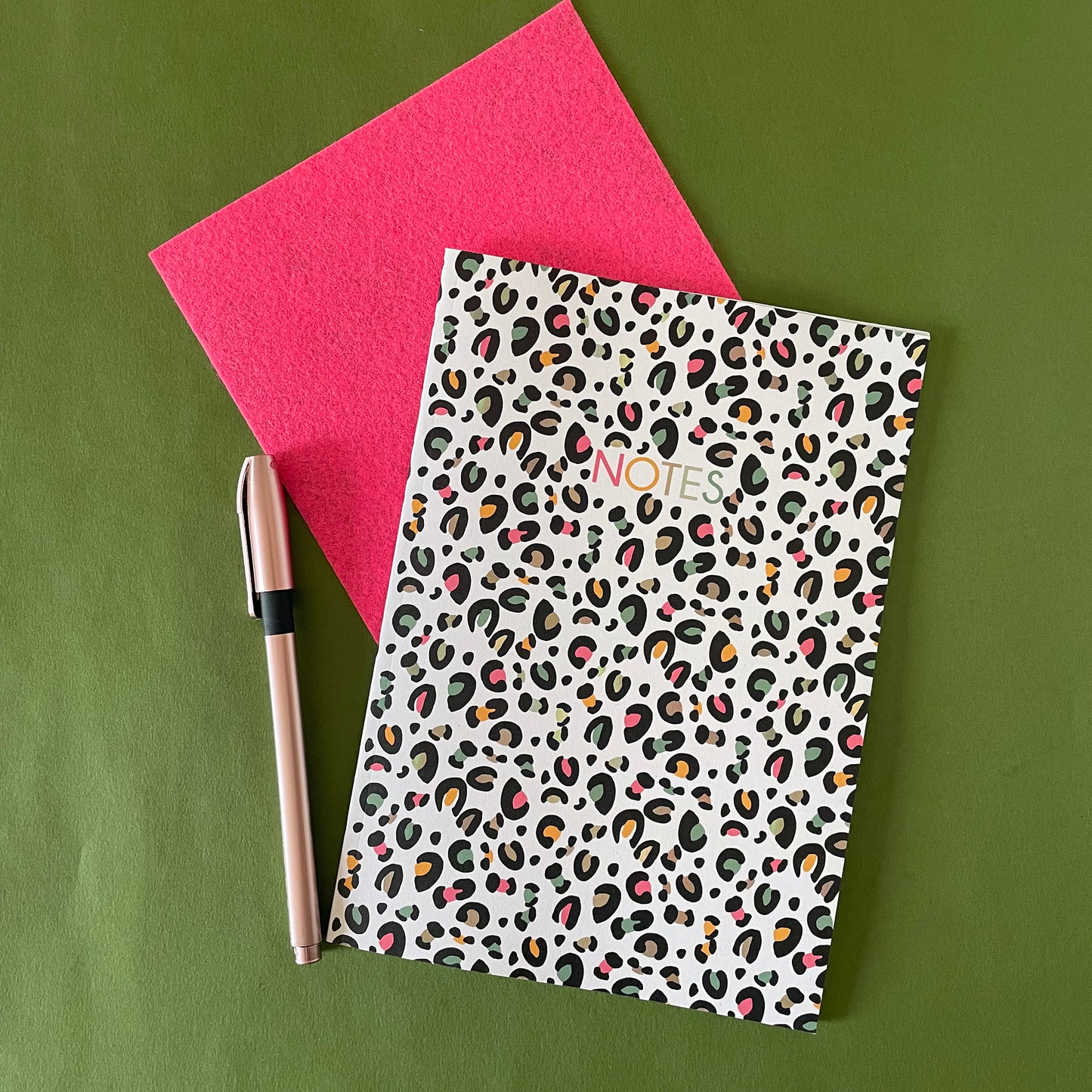 Image of a leopard print A5 size notebook in a cream colour with pops of neon.