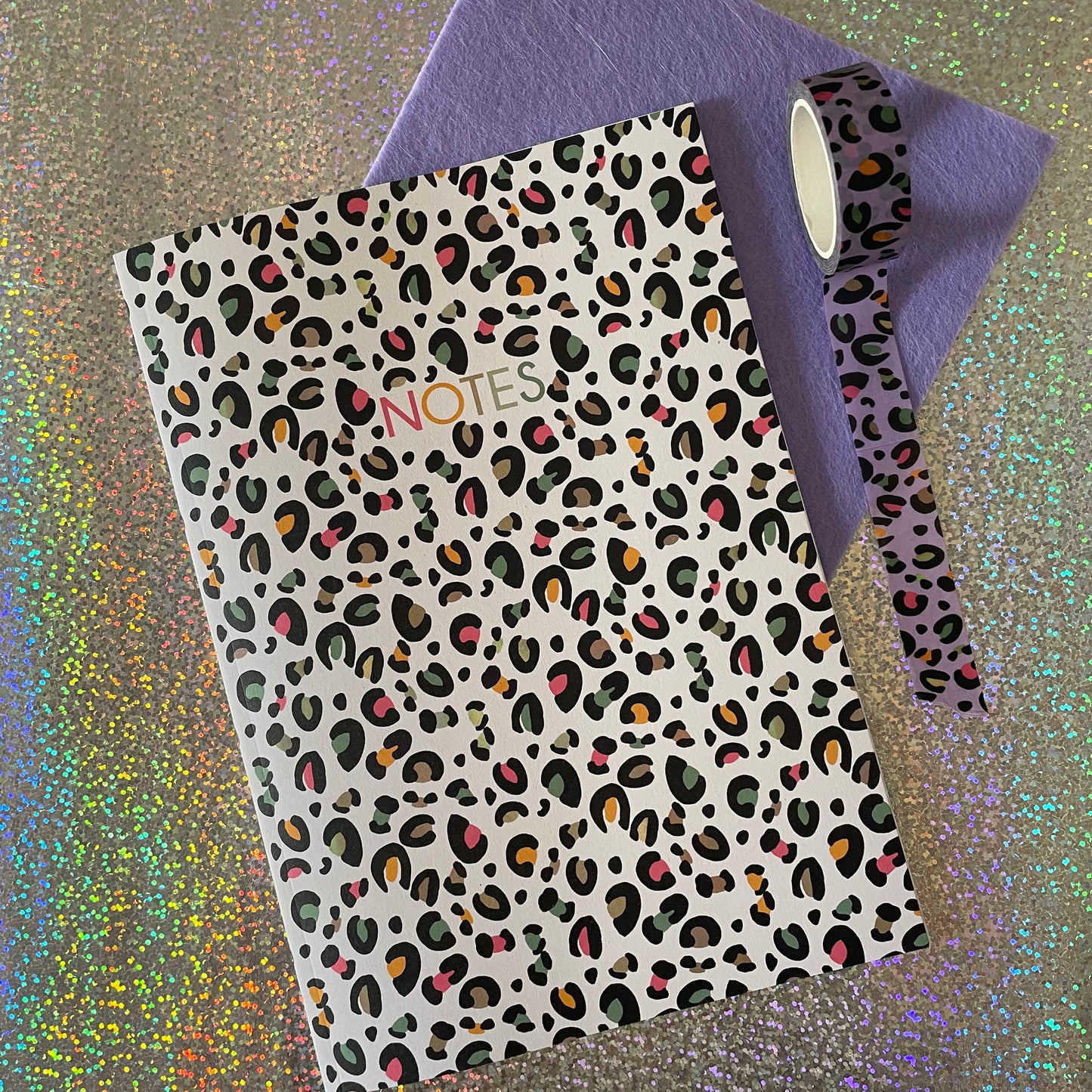 Image of a leopard print A5 size notebook in a cream colour with pops of neon.