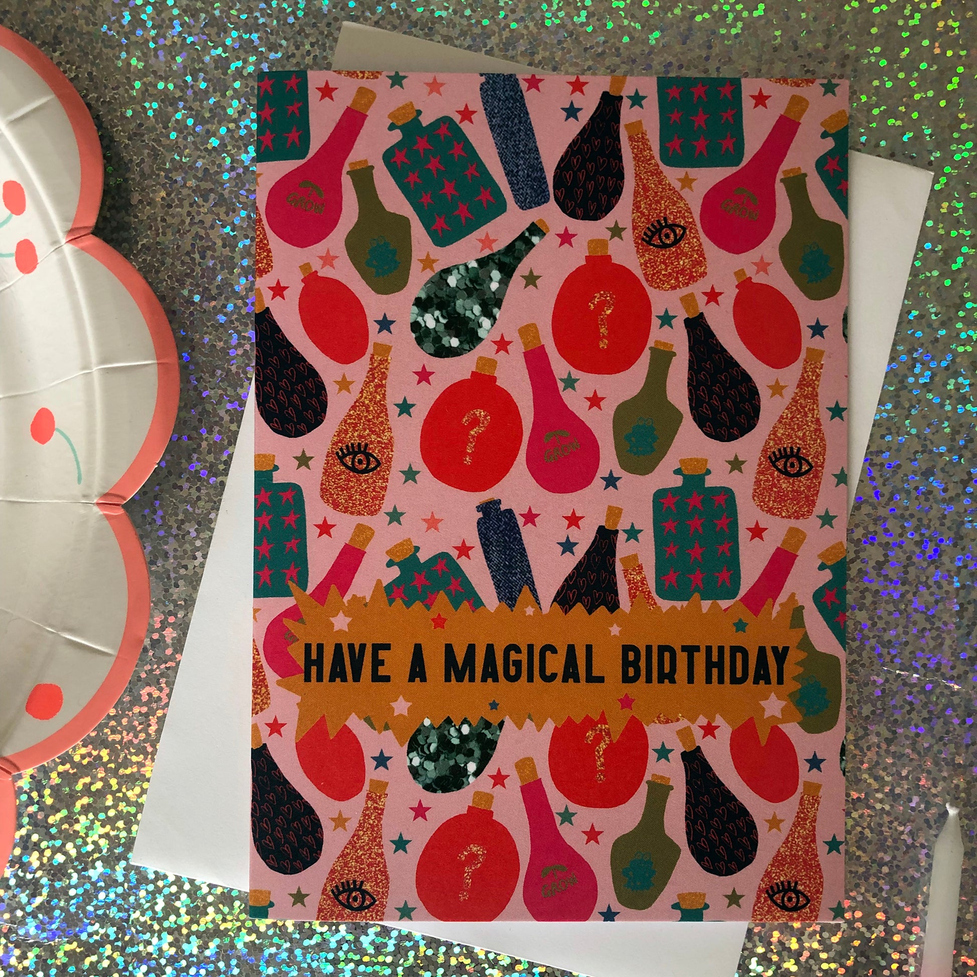 Image shows a fun, magical birthday card with colourful magic potion illustrations and the wording' have a magical birthday'
