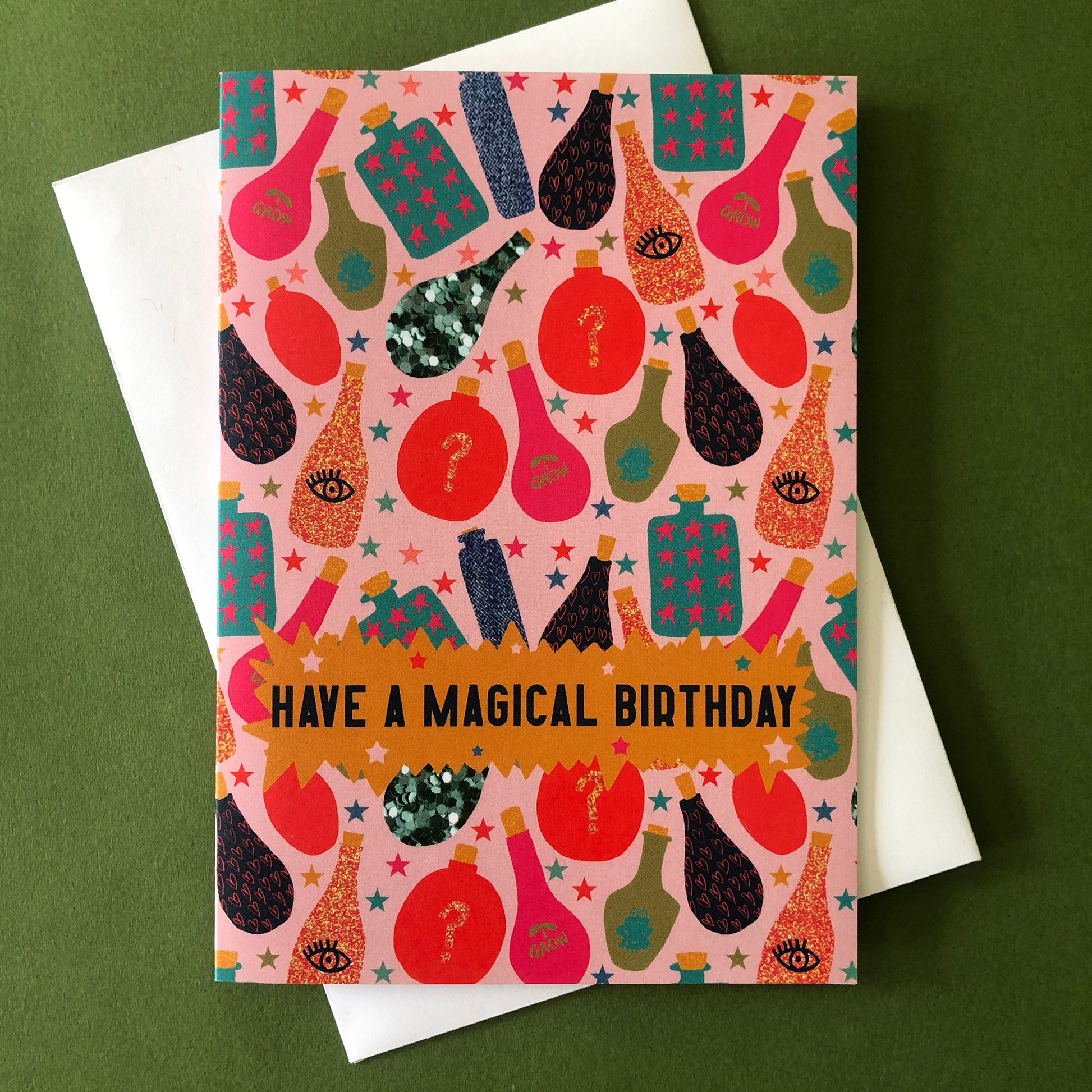 Image shows a fun, magical birthday card with colourful magic potion illustrations and the wording' have a magical birthday'