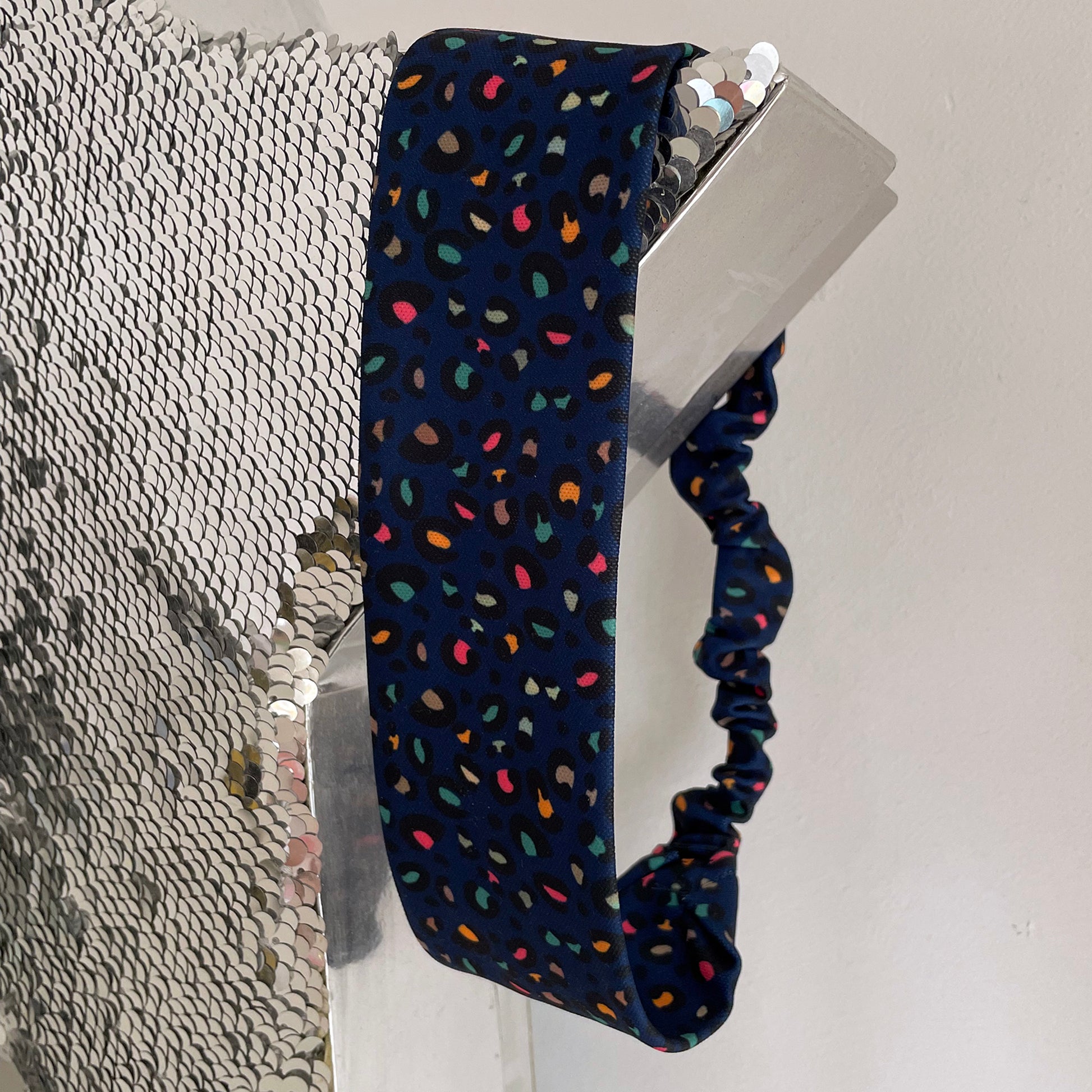 Image shows a stunning midnight blue leopard print hair band.