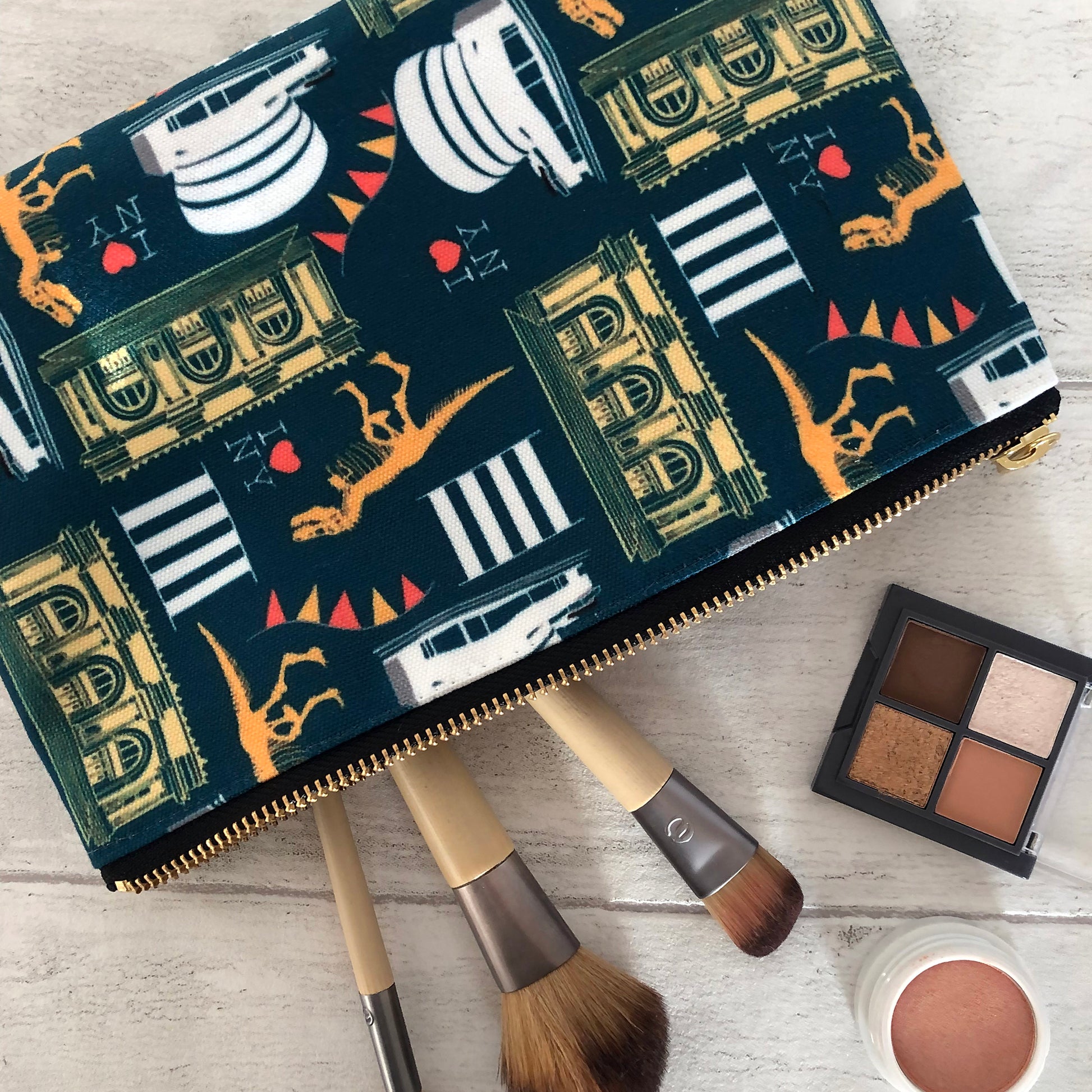 Image of a handy zip pouch in navy blue featuring unique illustrations of New York museums and galleries.
