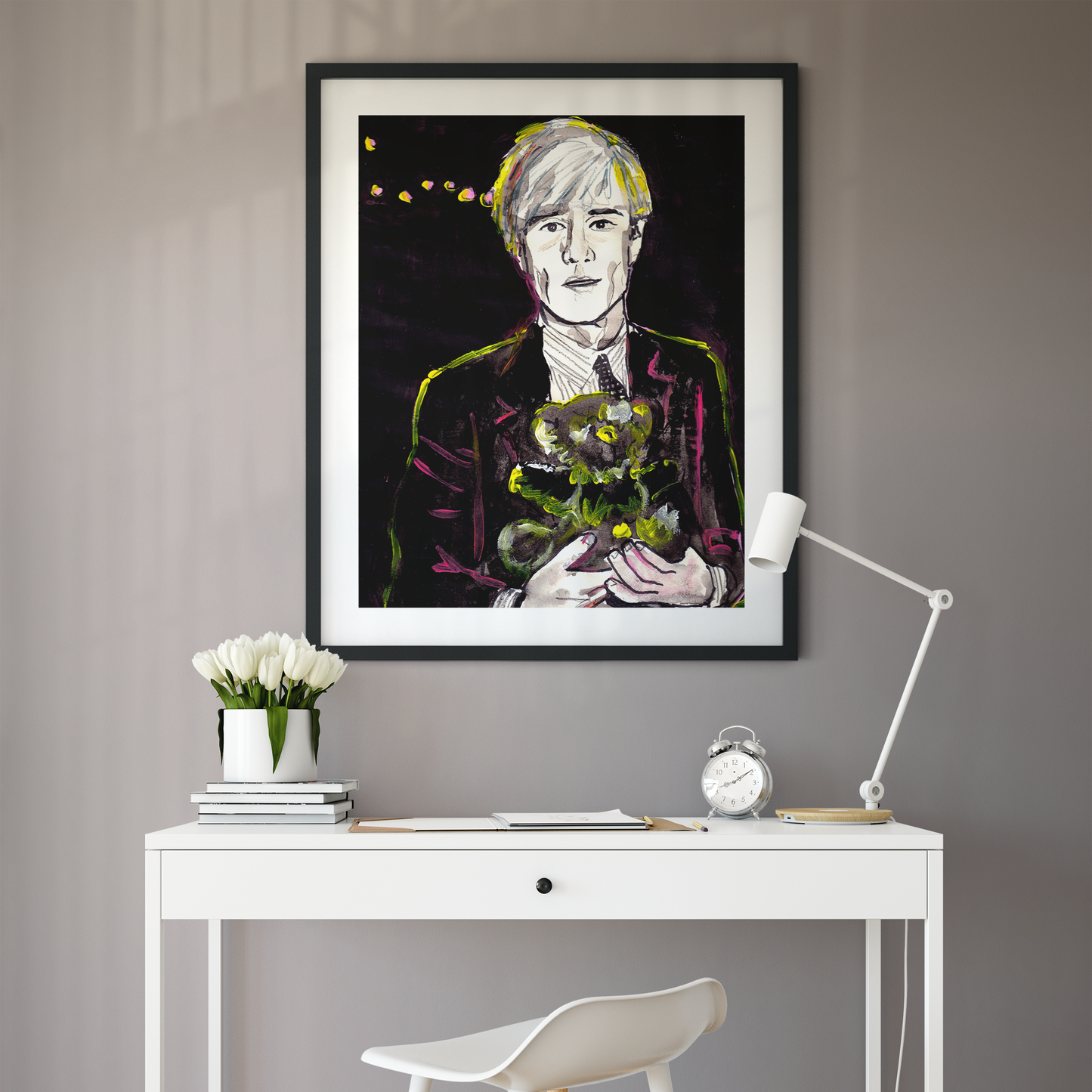 Image shows a framed portrait of artist Andy Warhol holding a teddy bear. The artwork is painted in black and white with neon pink and yellow highlights.