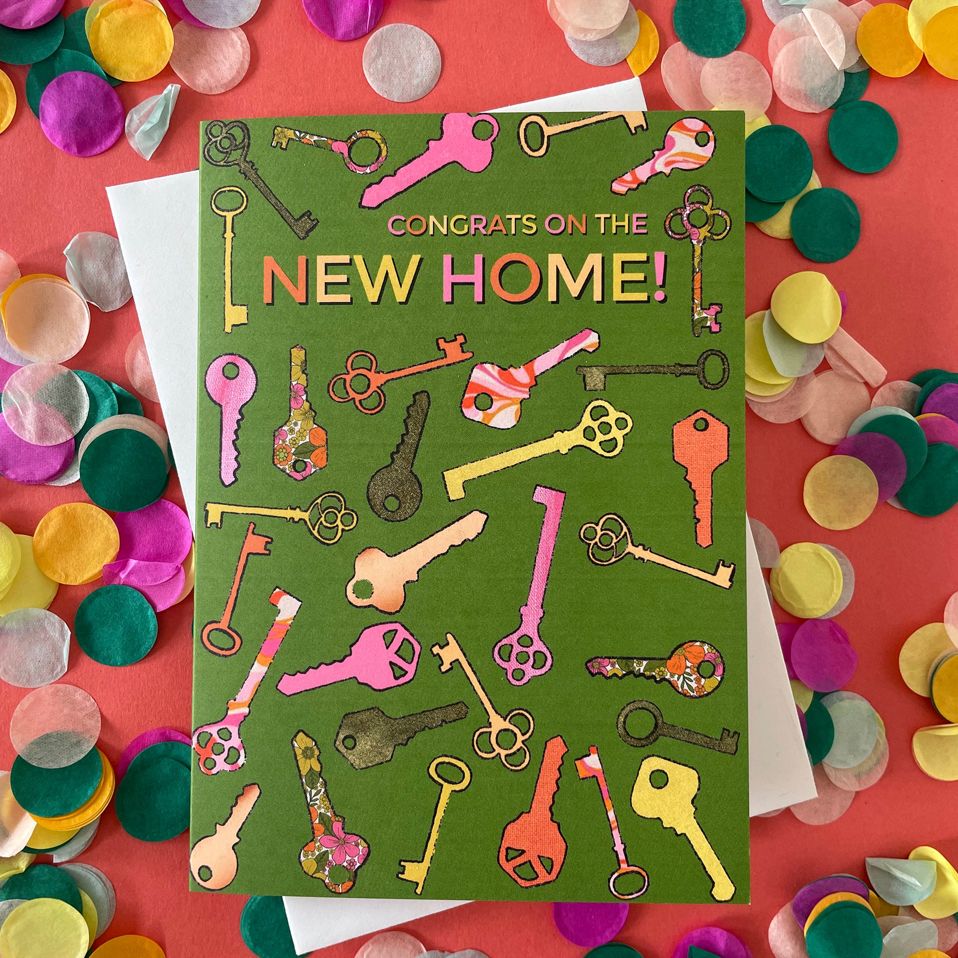 Image shows a green greetings card with a illustrations of colourful keys and the words 'Congrats on the new home'