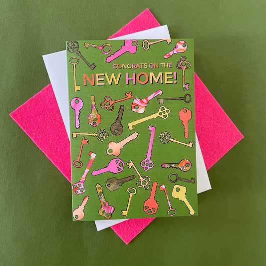 Image shows a green greetings card with a illustrations of colourful keys and the words 'Congrats on the new home'