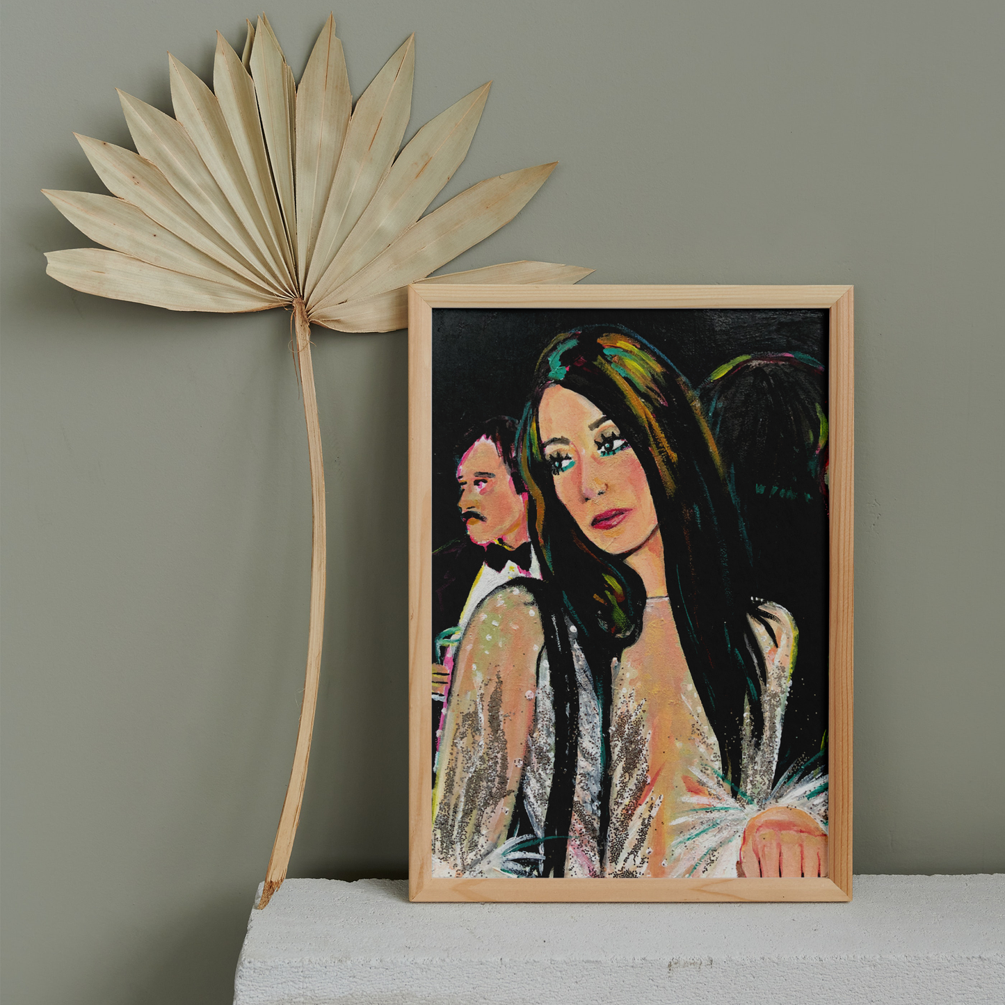 Image shows a framed portrait of Cher at studio 54 wearing a silver sparkly outfit with feathered sleeves.