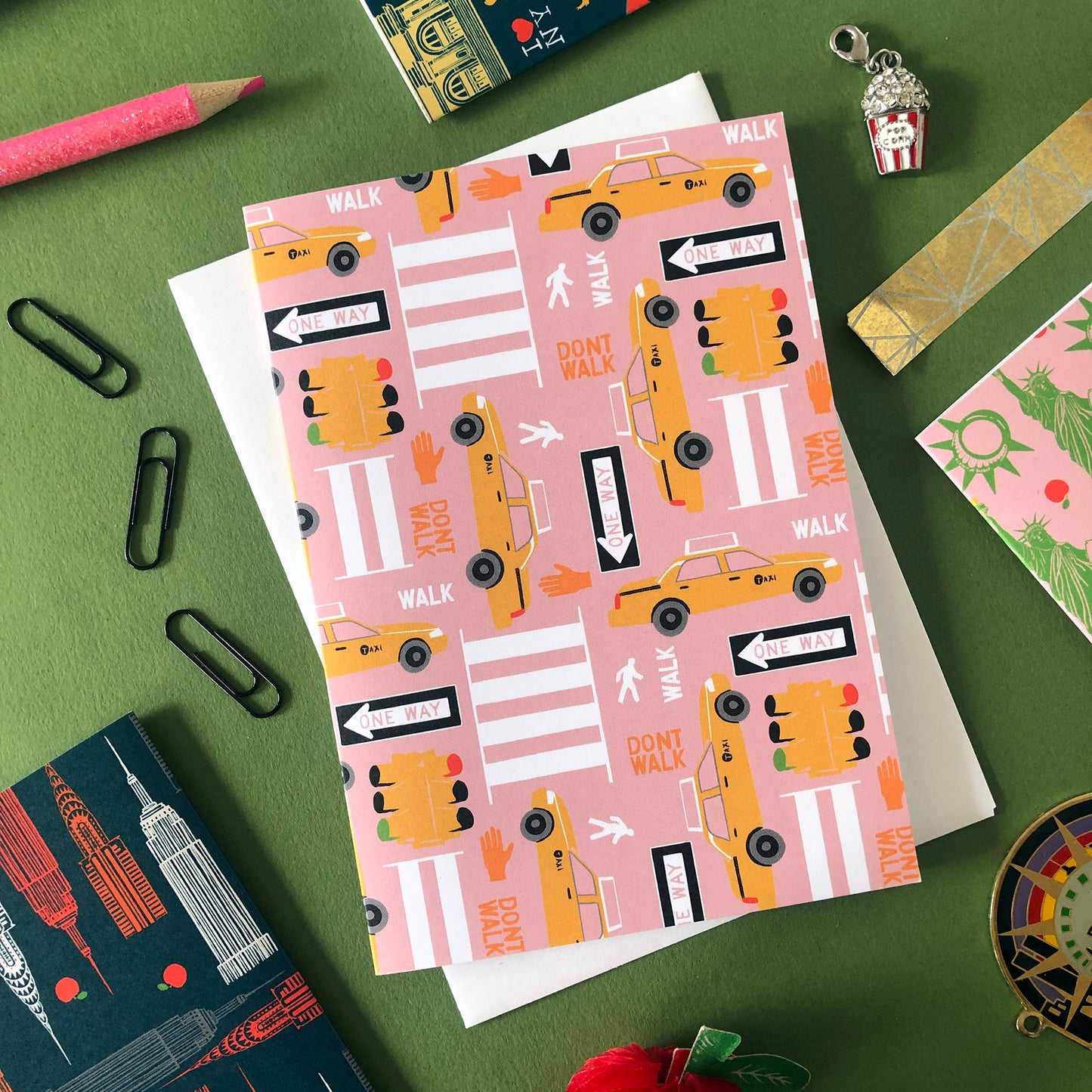 Image shows a graphic notecard inspired by the streets and yellow cabs of New York City.