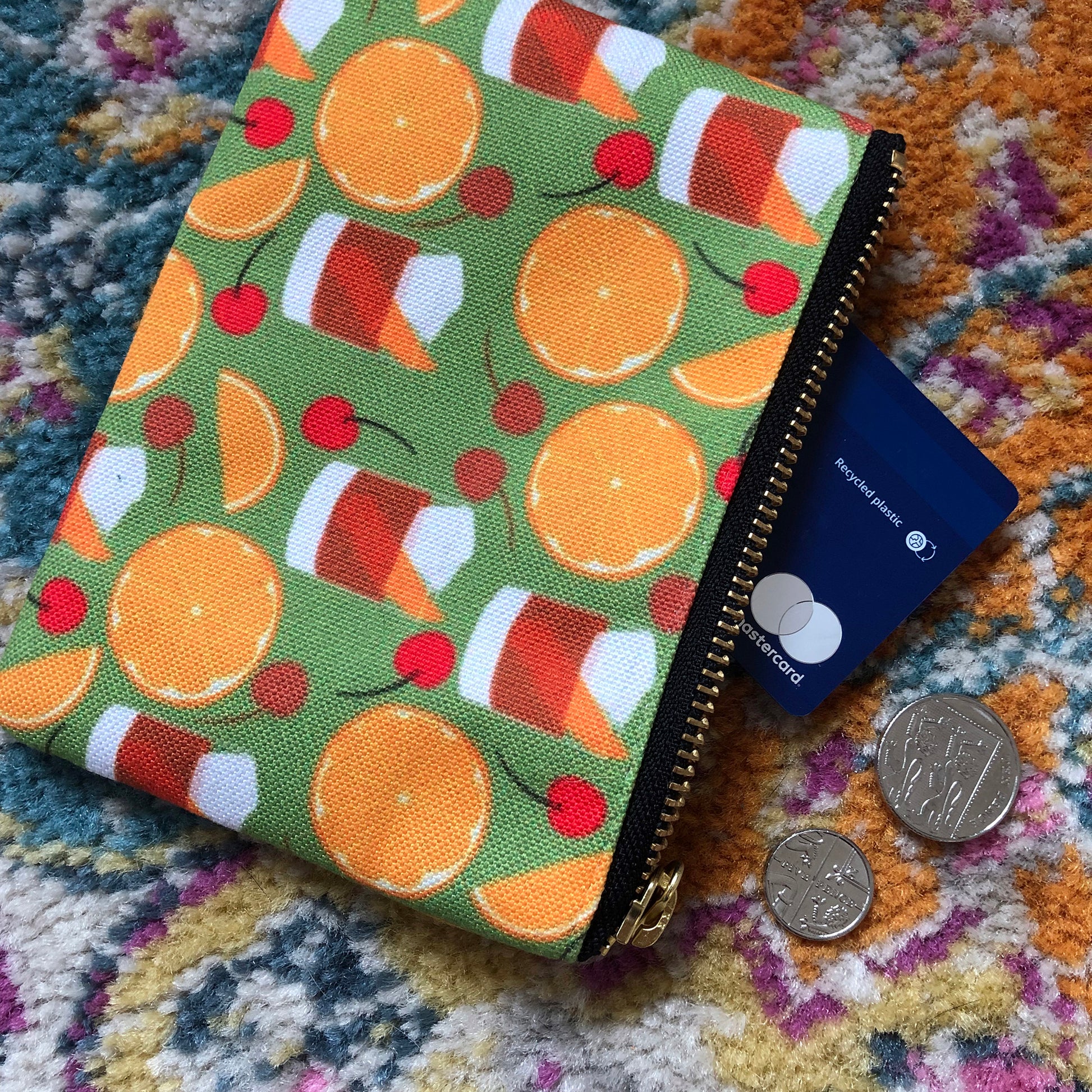 Image shows a handy zip pouch featuring a fun retro old fashioned cocktail inspired design