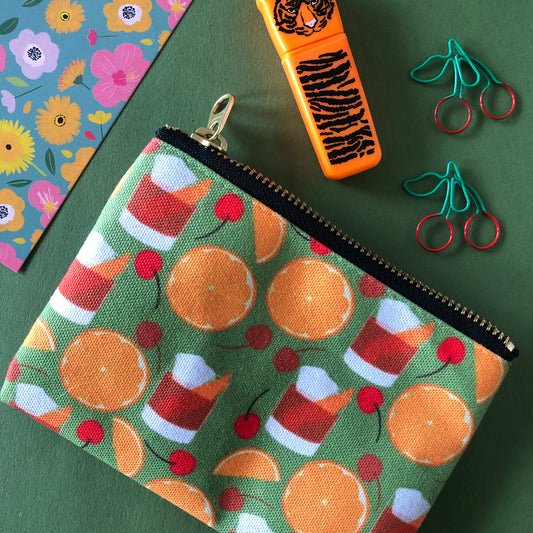 Image shows a handy zip pouch featuring a fun retro old fashioned cocktail inspired design