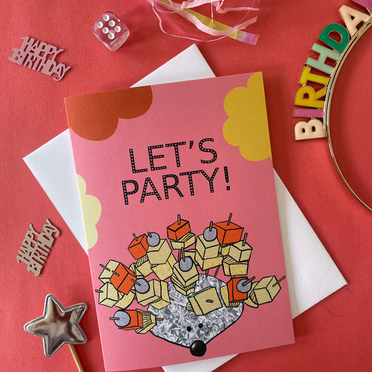 Image shows a pink greetings card with an illustration of a silver foil 'party hedgehog' with cheese, pineapple and pickled onions on cocktail sticks and the words 'let's party'