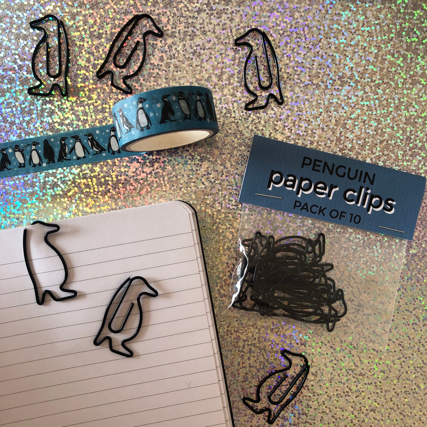 Image shows a set of black penguin shaped paperclips.