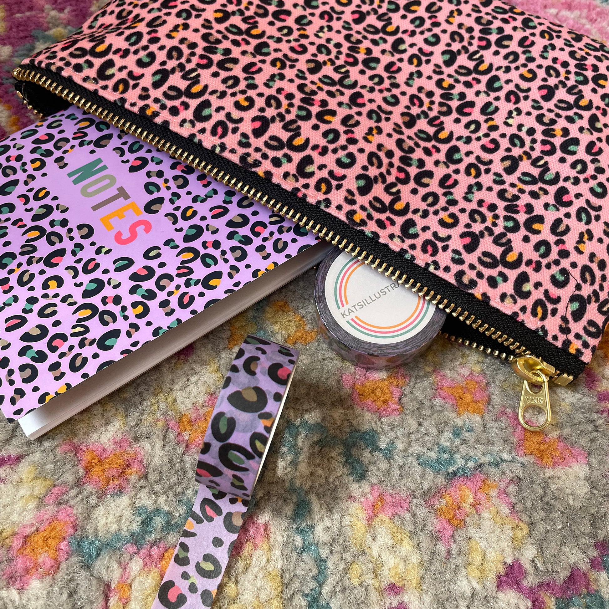 Image shows a useful zip pouch in a pretty pink colour with a leopard print pattern with pops of neon.