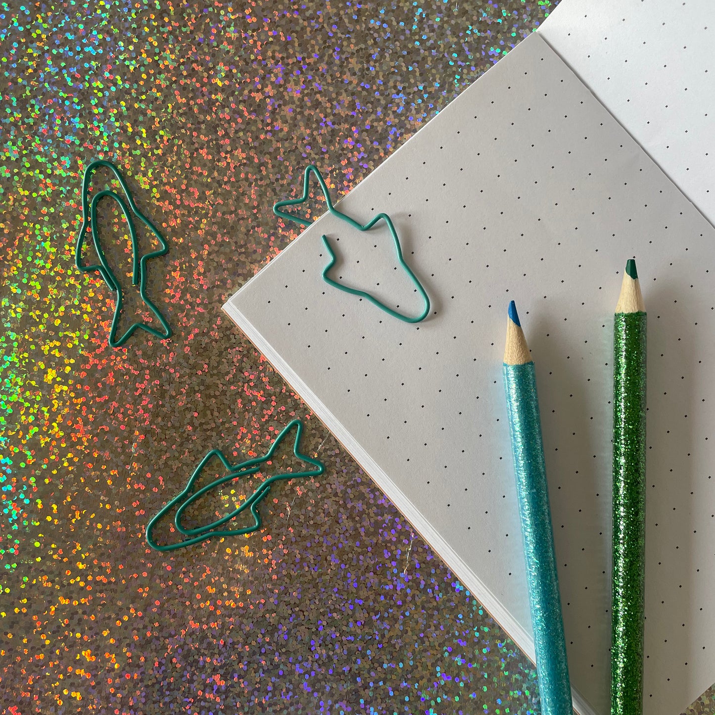 Image shows a fun set of 5 turquoise paper clips shaped like sardines