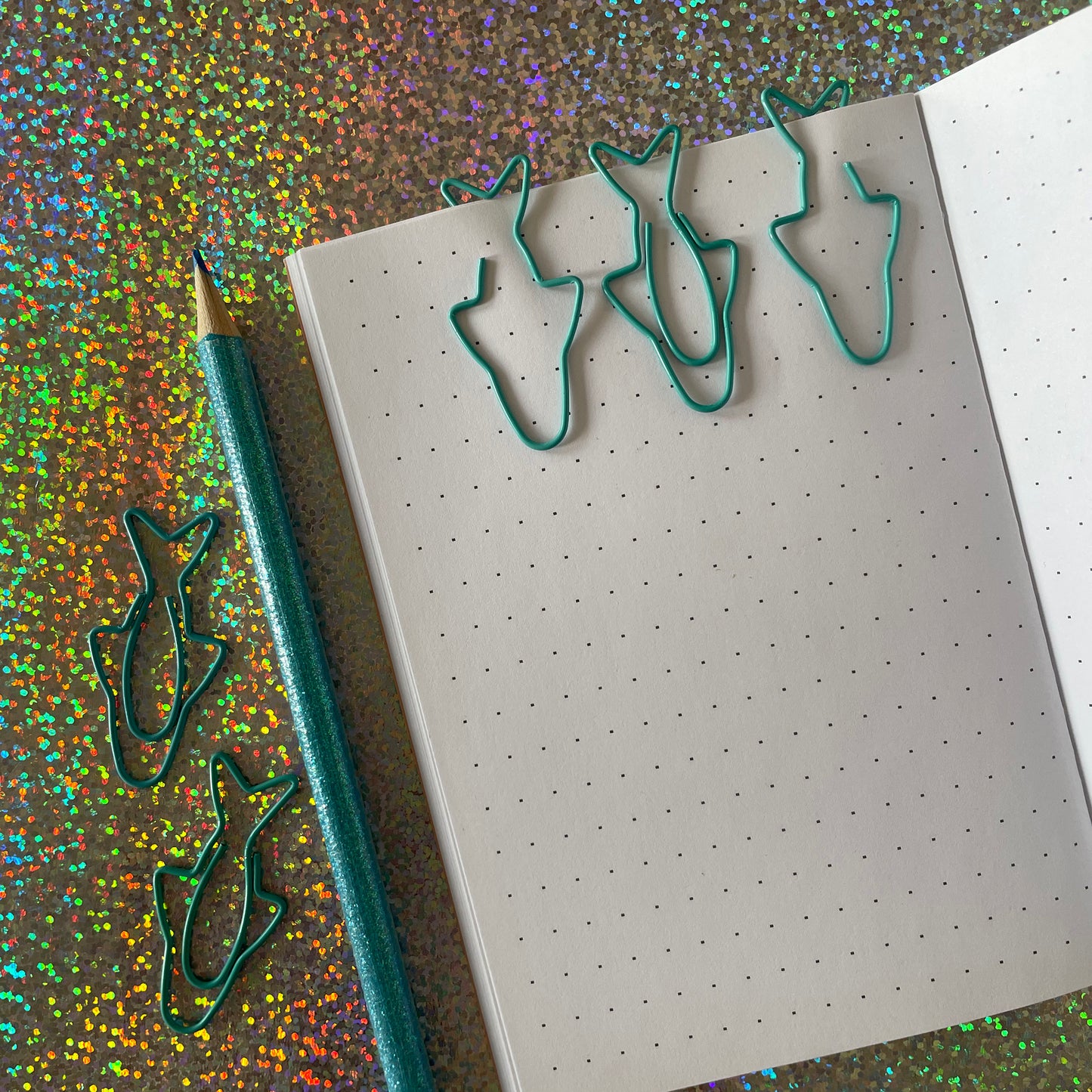 Image shows a fun set of 5 turquoise paper clips shaped like sardines