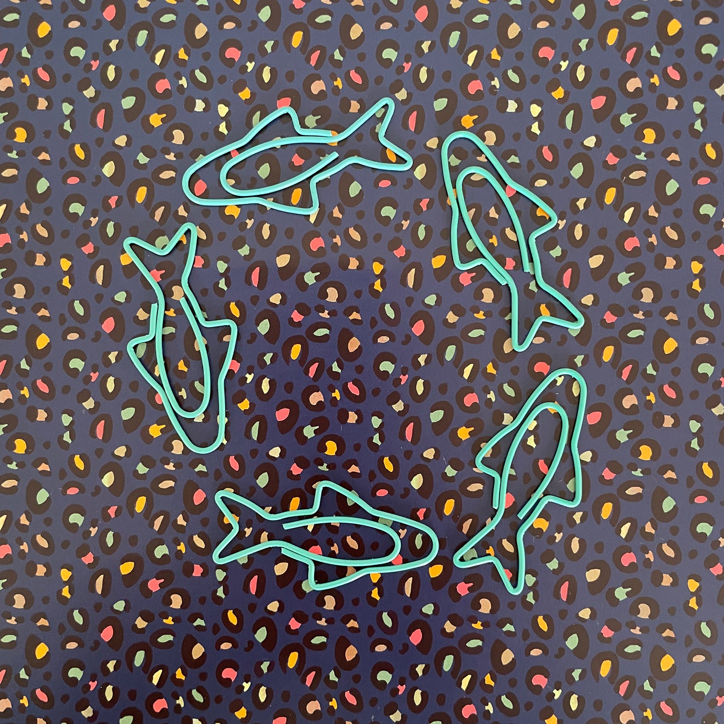 Image shows a fun set of 5 turquoise paper clips shaped like sardines