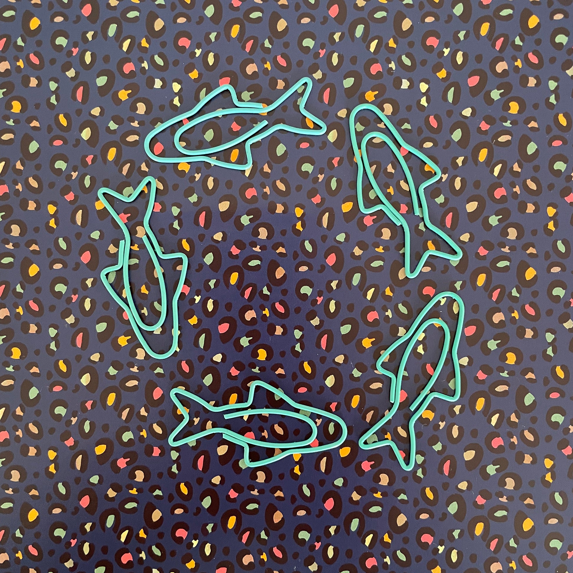 Image shows a fun set of 5 turquoise paper clips shaped like sardines