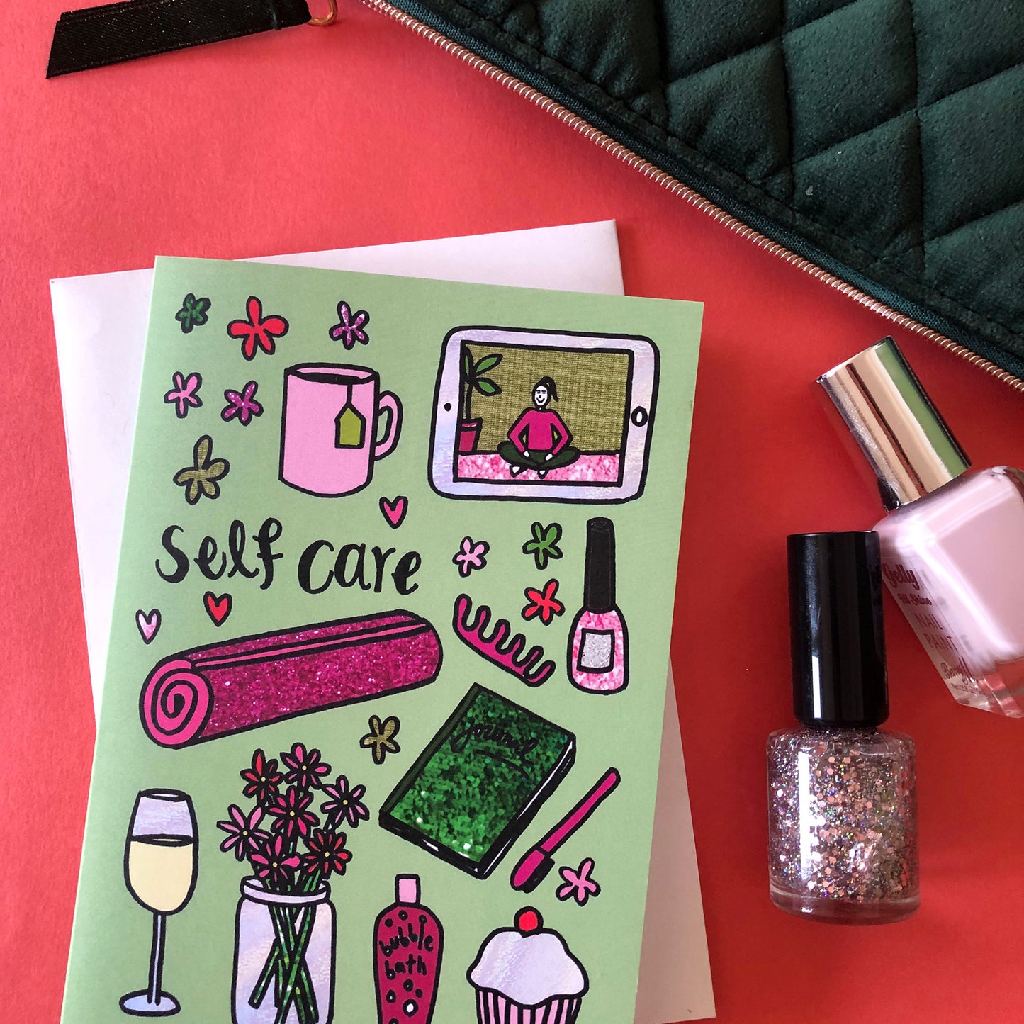 Image show a green greetings card that says 'self care' and features a fun pattern of self care items