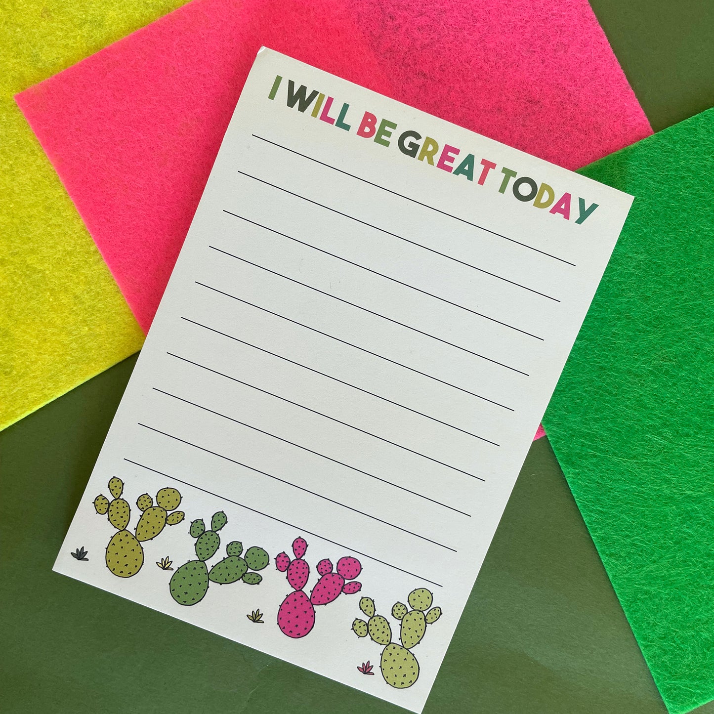 Image shows a lined a6 notepad with neon cactus illustrations and the words 'I will be great today'