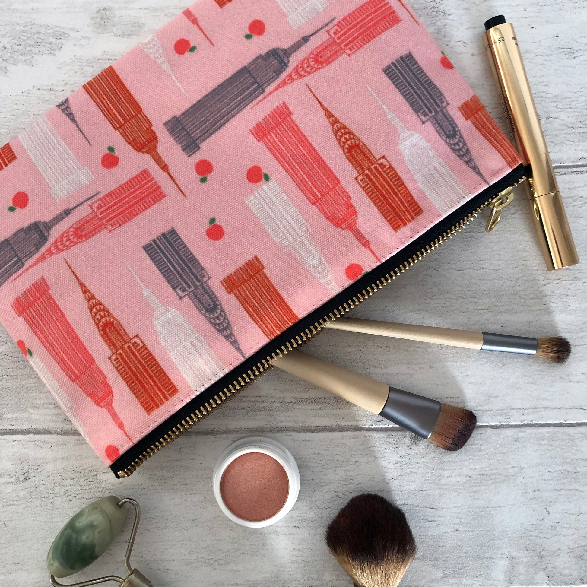 Handy zip pouch in pastel pink featuring a unique design inspired by the skyscrapers of NYC