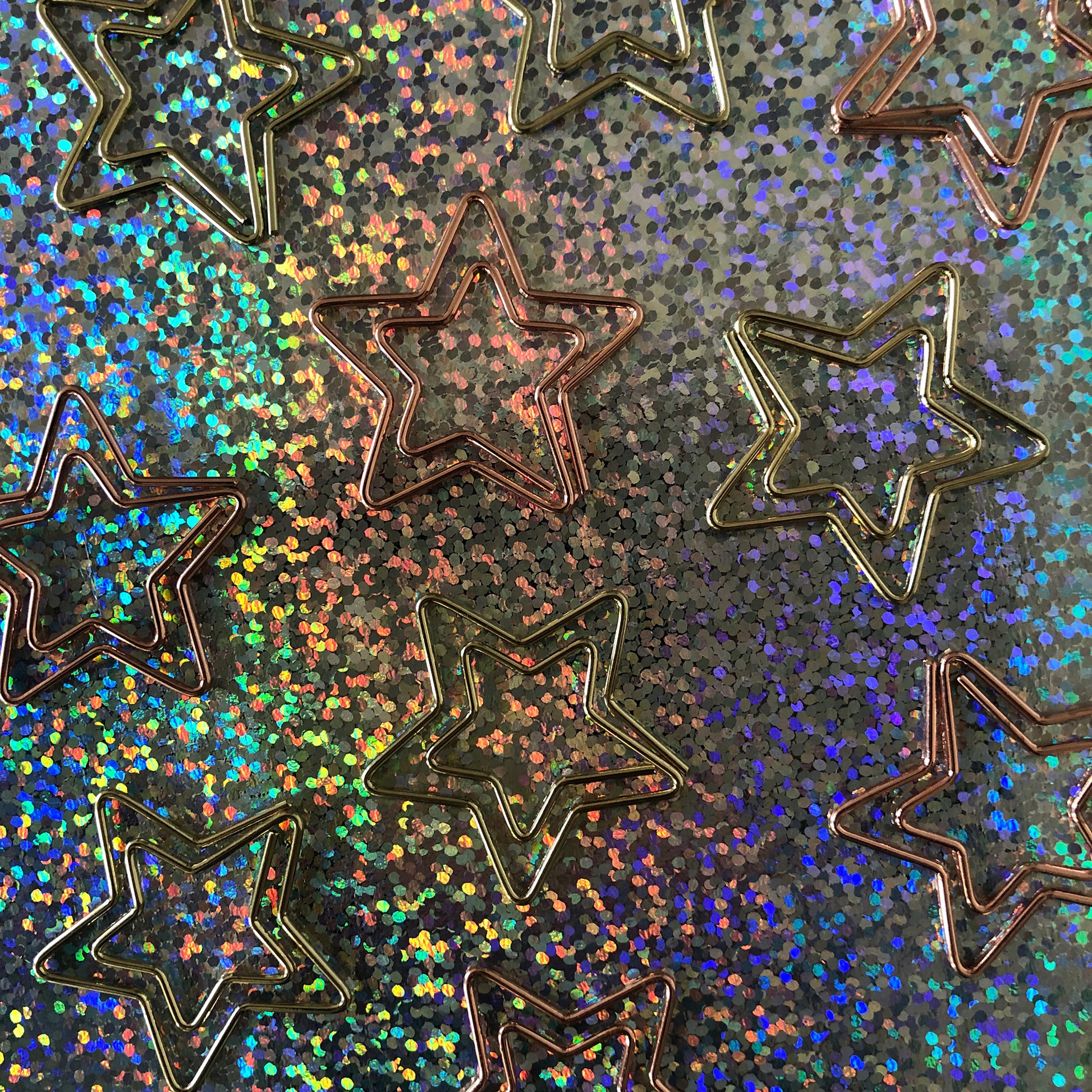Image shows a set of gold and rose gold, star shaped paperclips.
