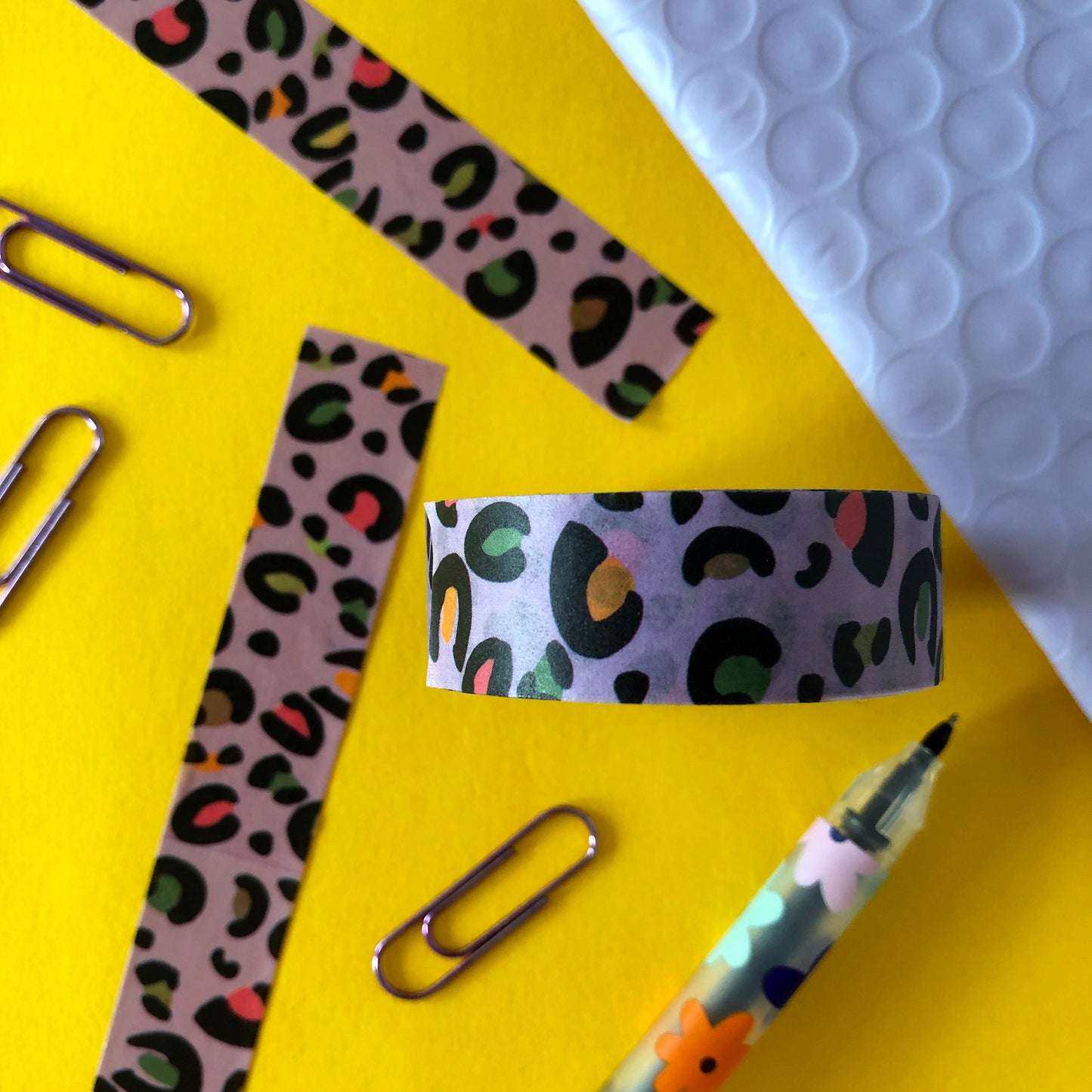 Image shows a purple leopard print washi tape with pops of neon colour