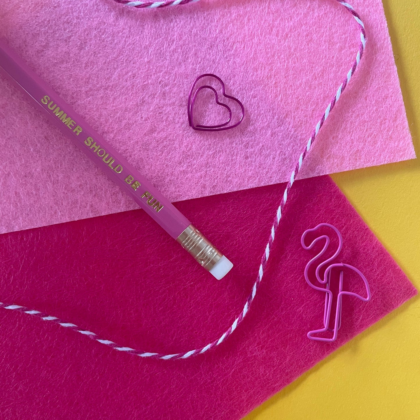 Image of a pink pencil with the words summer should be fun' embossed in gold lettering