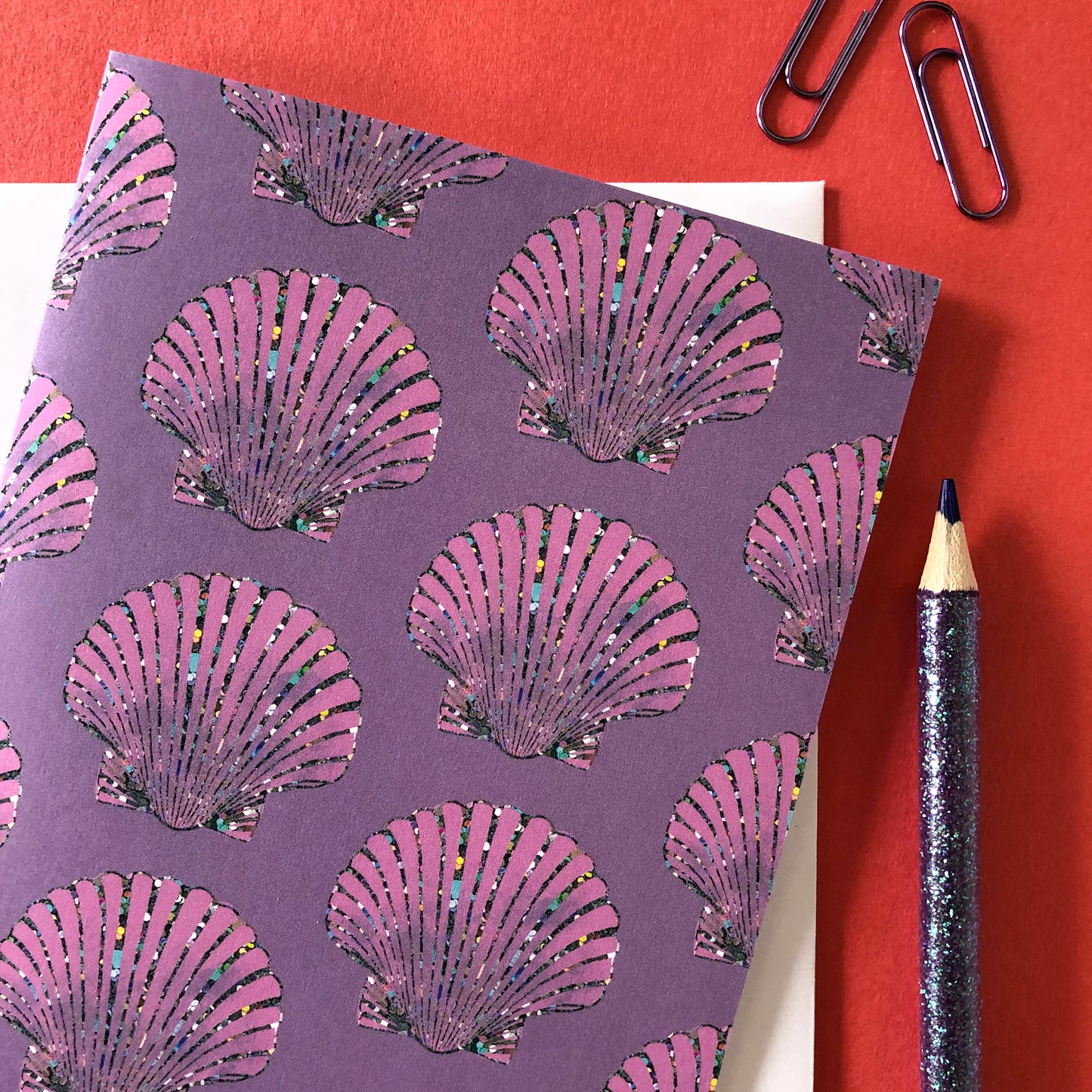 Image shows an illustrated notecard featuring vibrant summer shells pattern