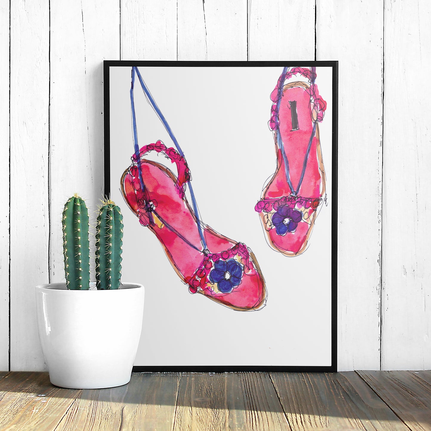 Framed art print of an ink illustration of a pair of pink and purple sandals with flowers on them.