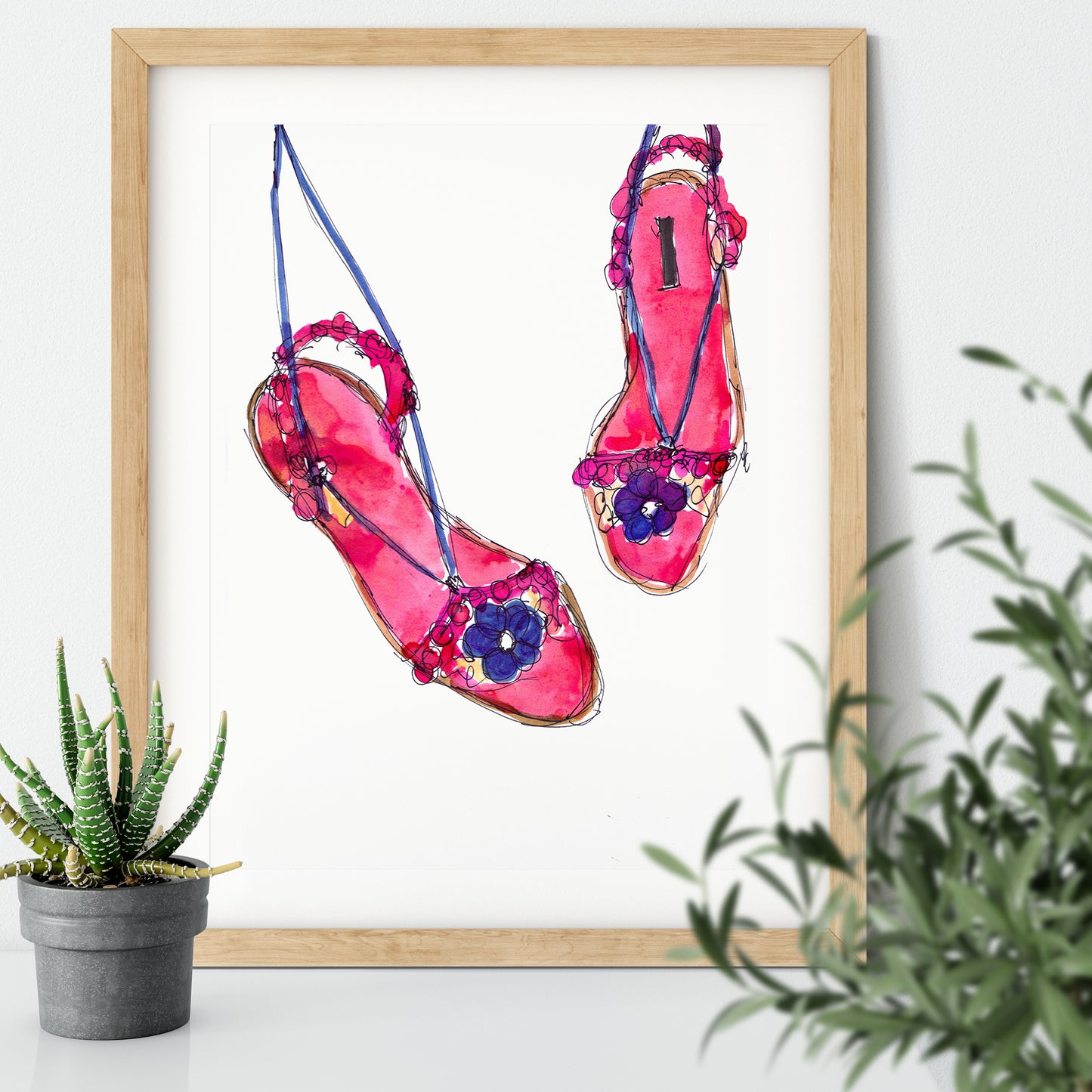 Framed art print of an ink illustration of a pair of pink and purple sandals with flowers on them.