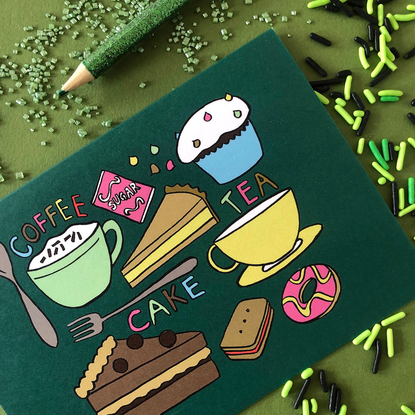 Image shows a green illustrated notecards featuring delicious tea time treats.