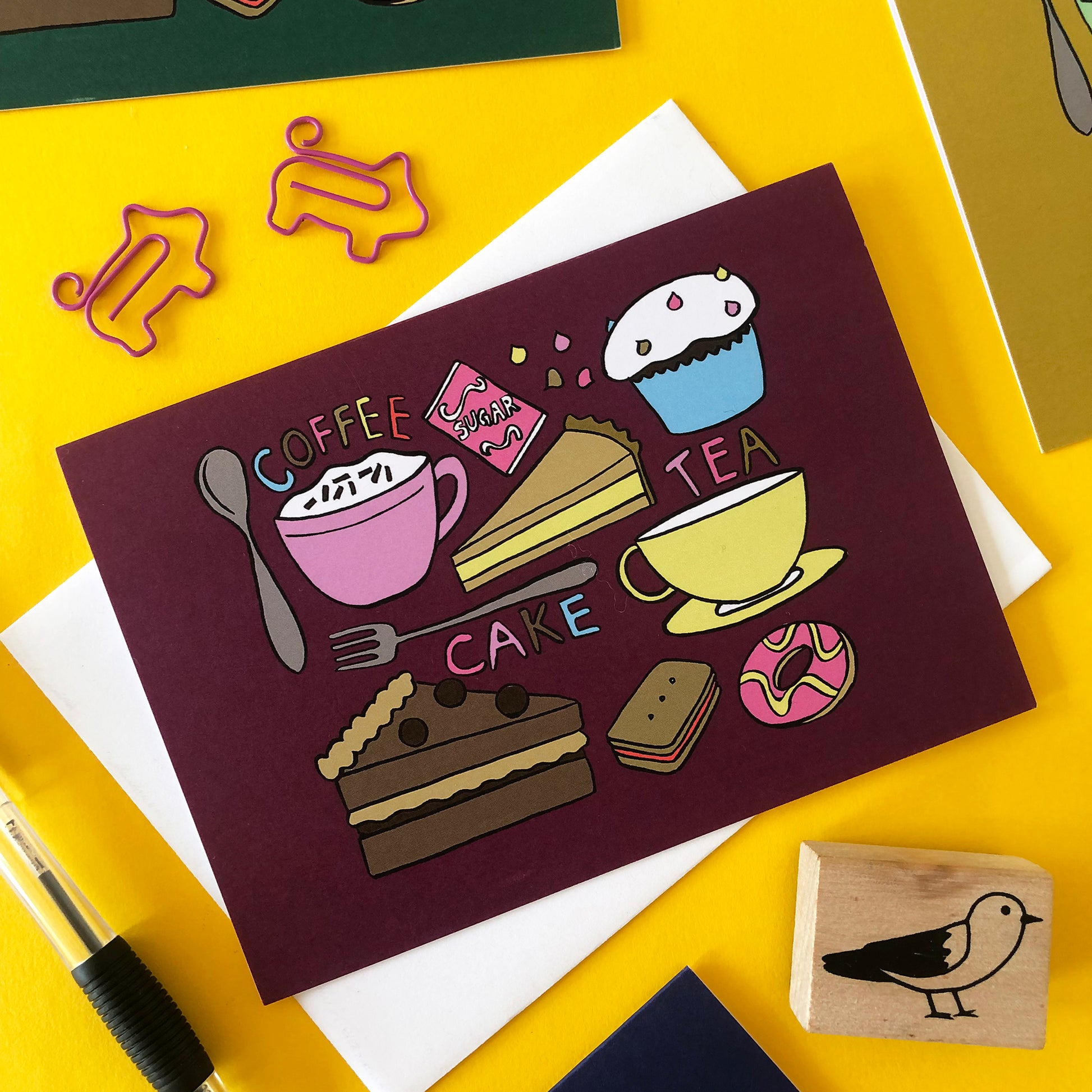 Image shows a plum coloured illustrated notecard featuring delicious tea time treats.