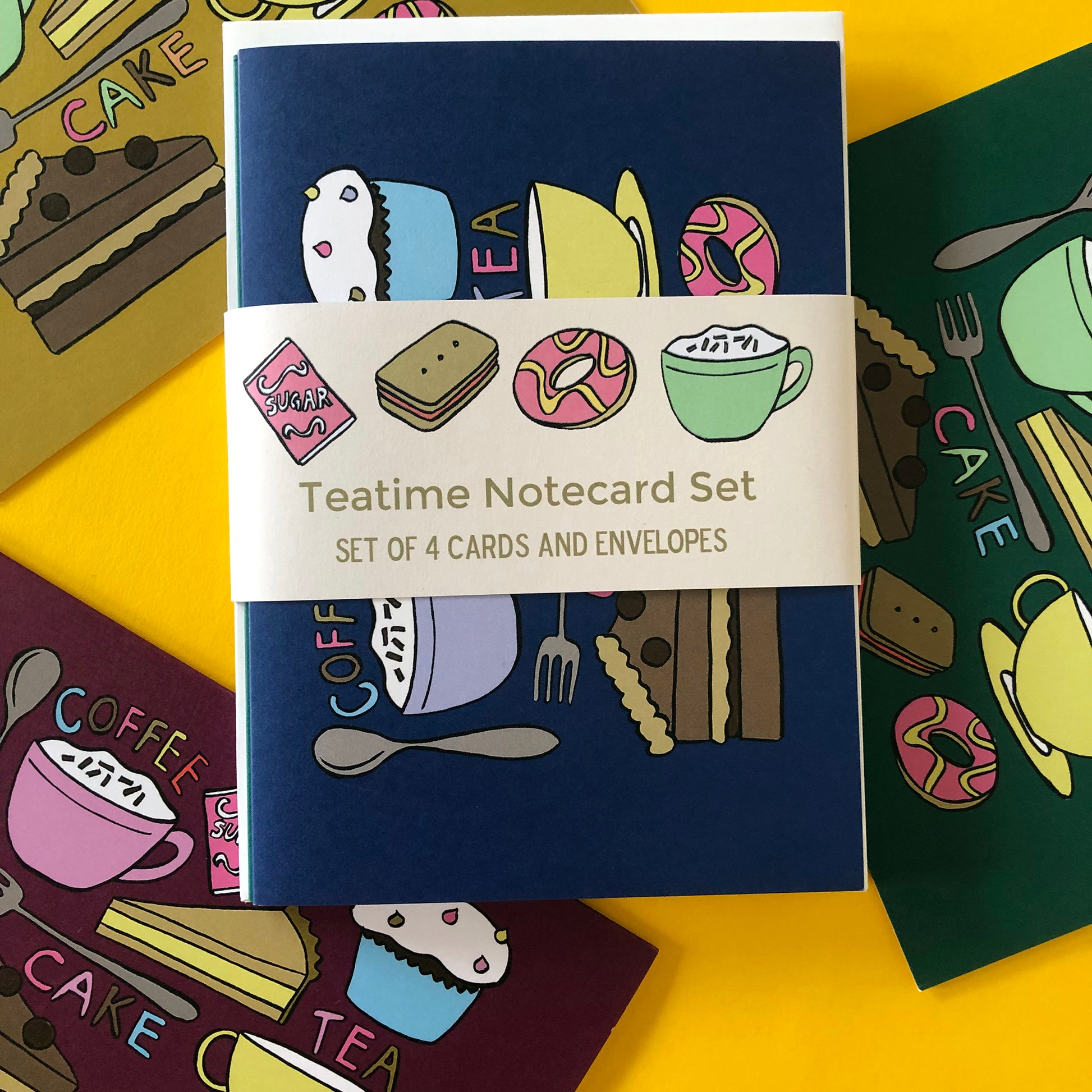 Image shows a set of 4 brightly coloured illustrated notecards featuring delicious tea time treats.