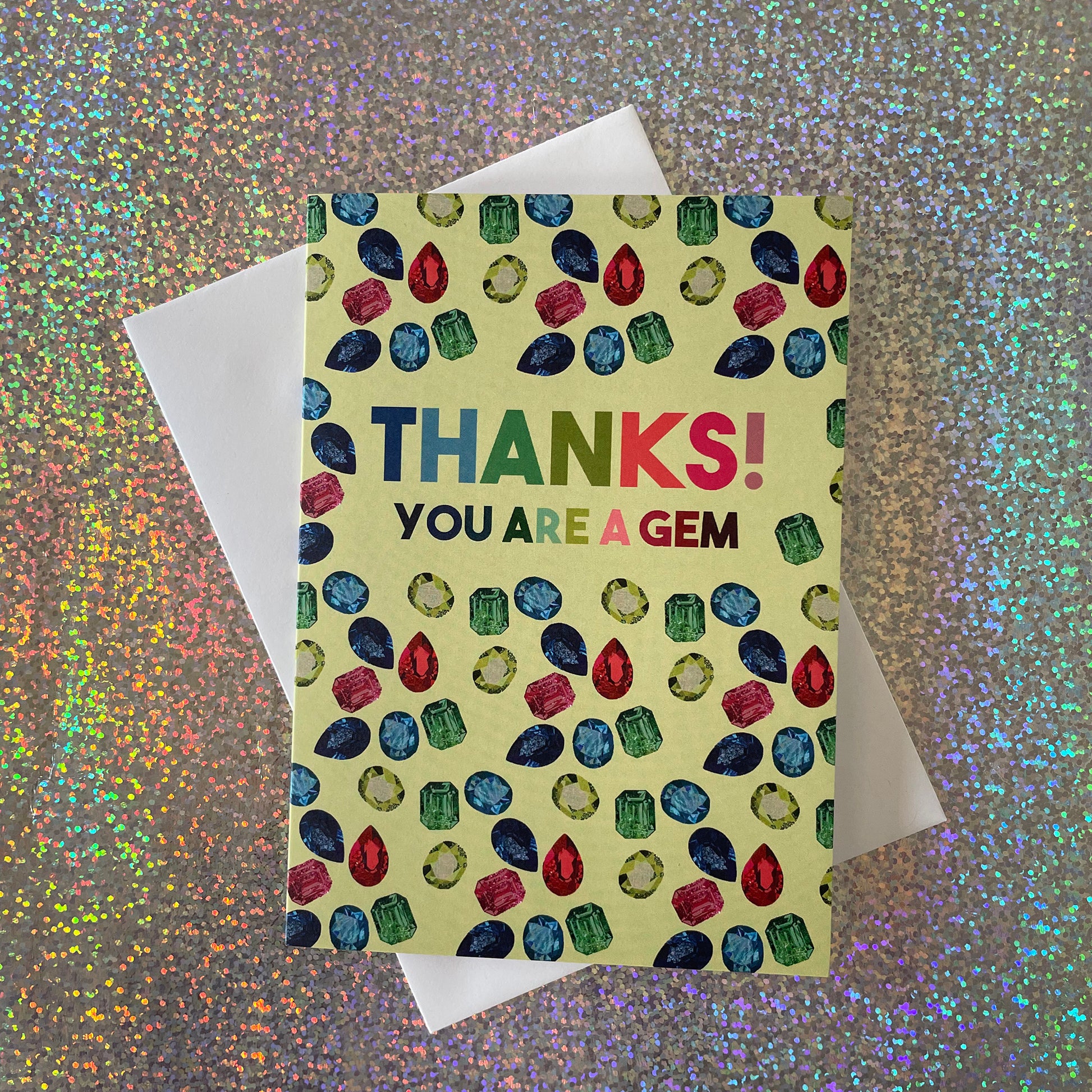 Image shows a light green greetings card with illustrations of gemstones and the words 'thanks you are a gem"