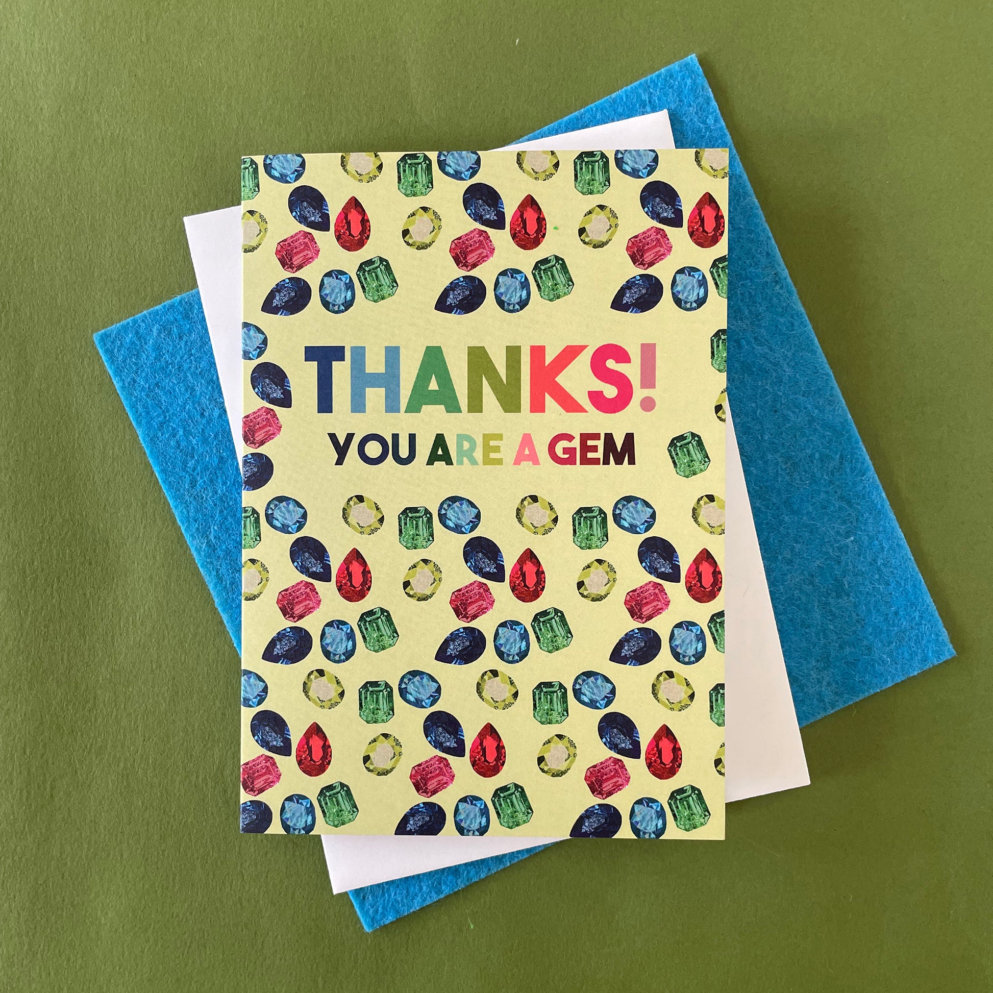 Image shows a light green greetings card with illustrations of gemstones and the words 'thanks you are a gem"