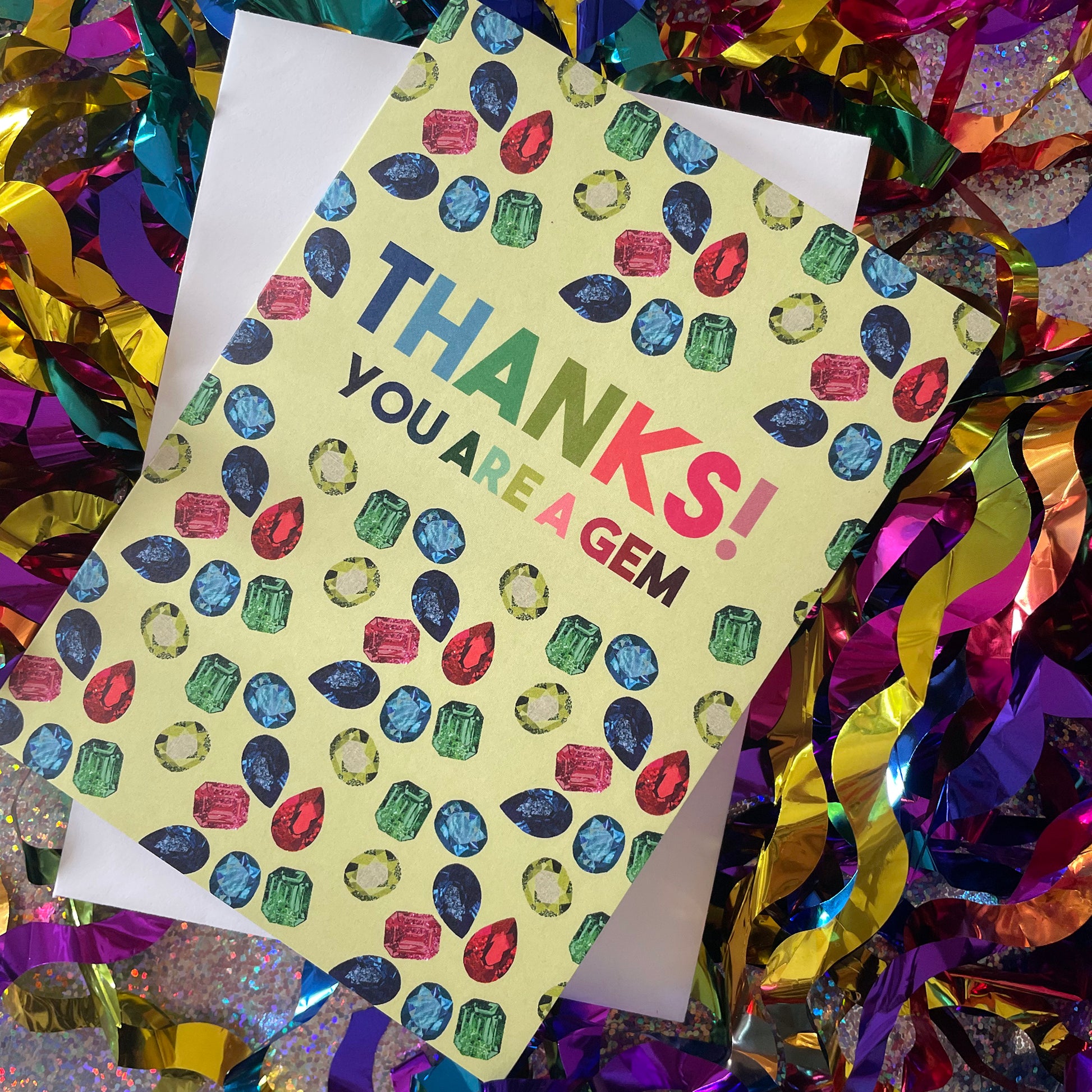 Image shows a light green greetings card with illustrations of gemstones and the words 'thanks you are a gem"