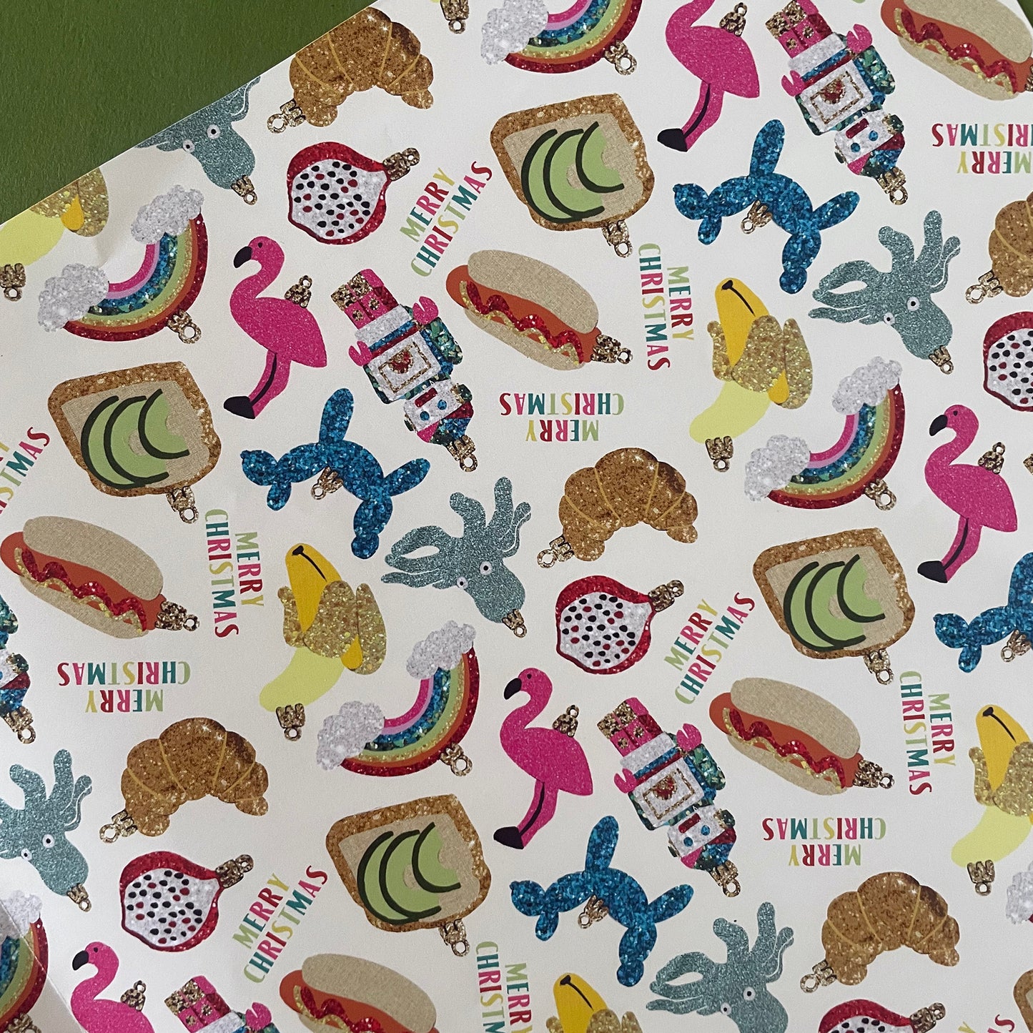 Image shows a gift wrap sheet in a fun trinkets design featuring a quirky bauble pattern.