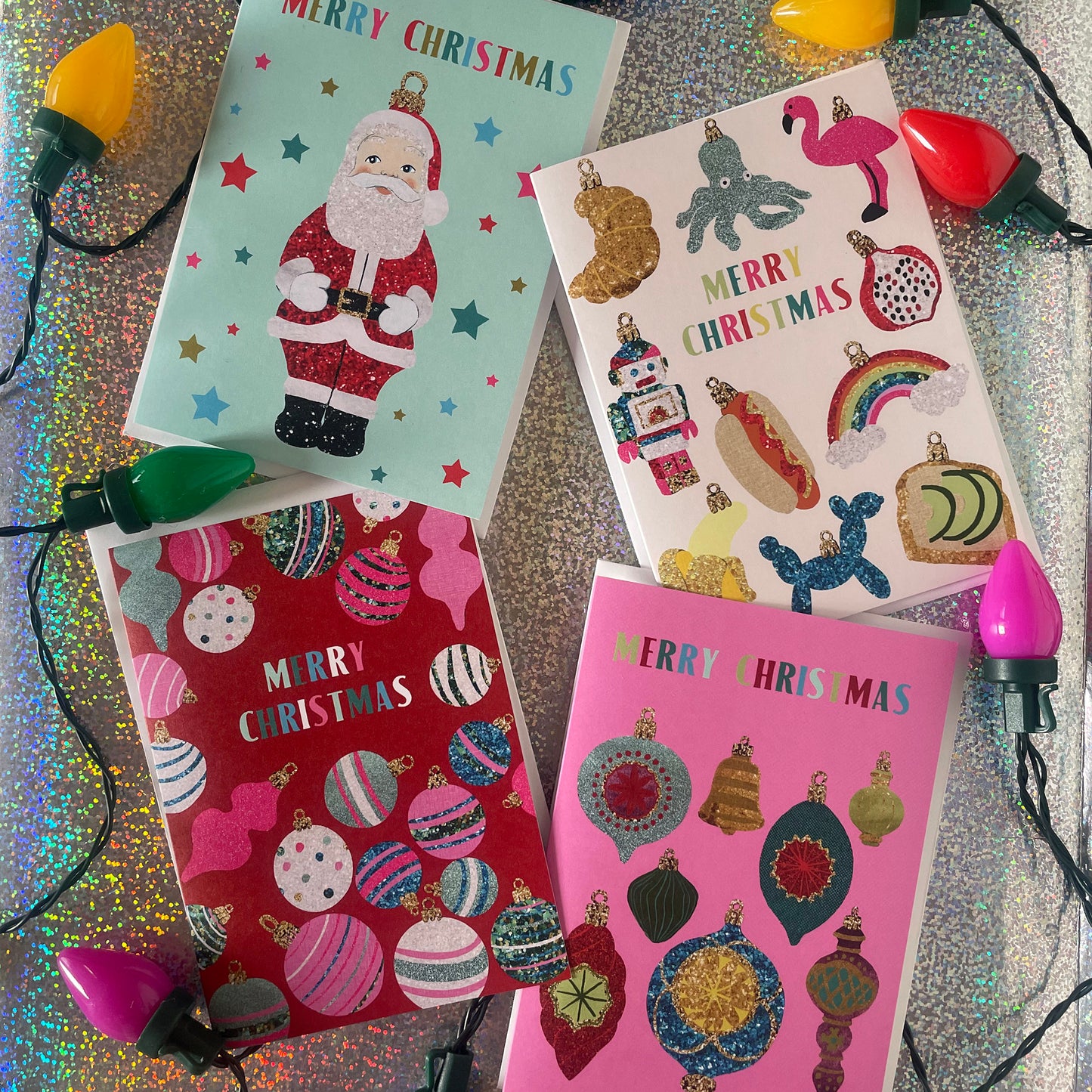 Image shows a collection of colourful Christmas cards with fun designs inspired by baubles.
