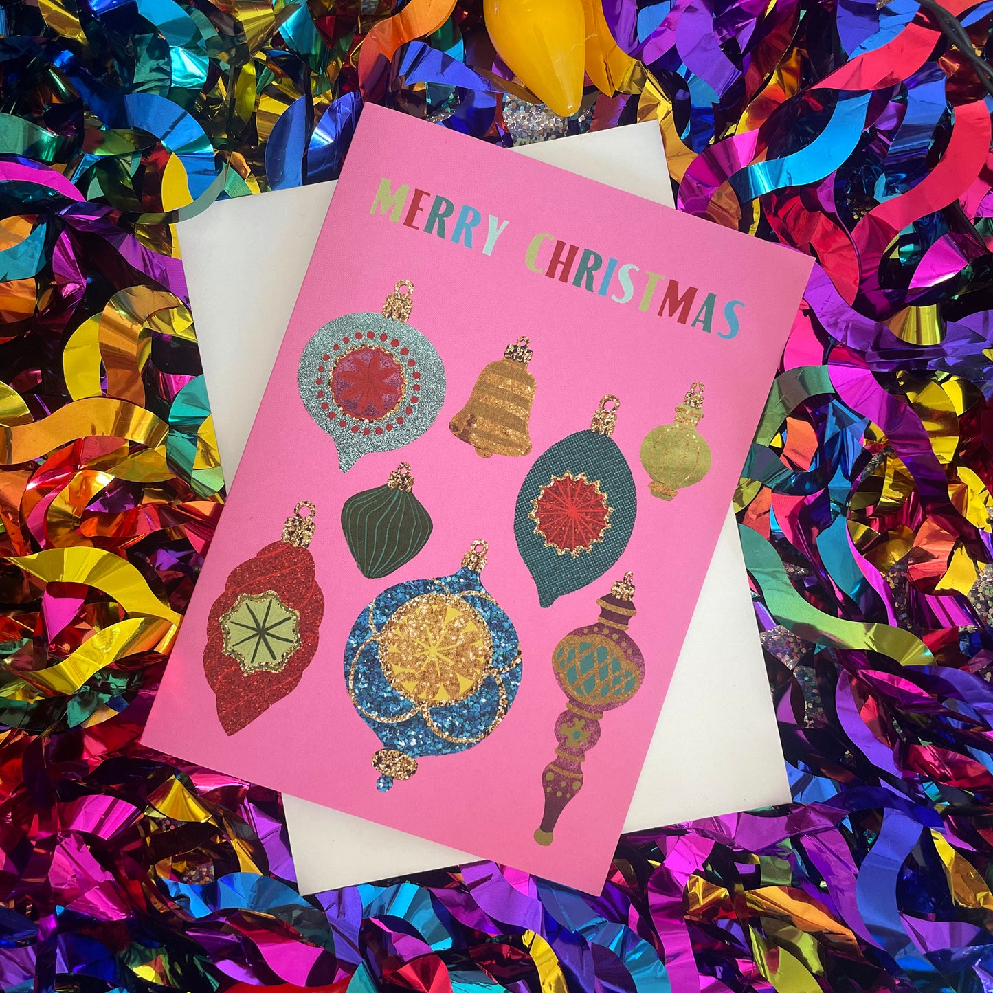 Image shows a colourful Christmas card with fun designs inspired by baubles.