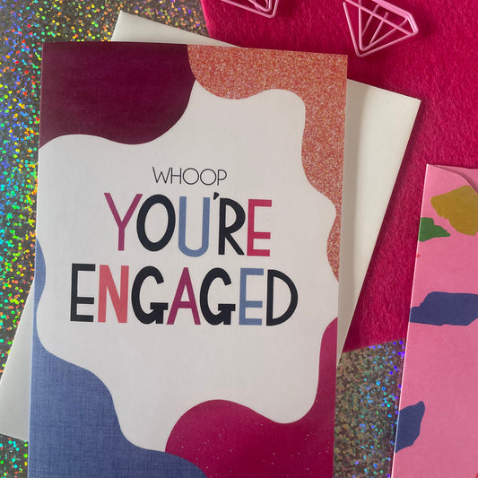 Image shows a bright greetings card with colourful, abstract shapes around the edge and the wording "Whoop you're engaged""