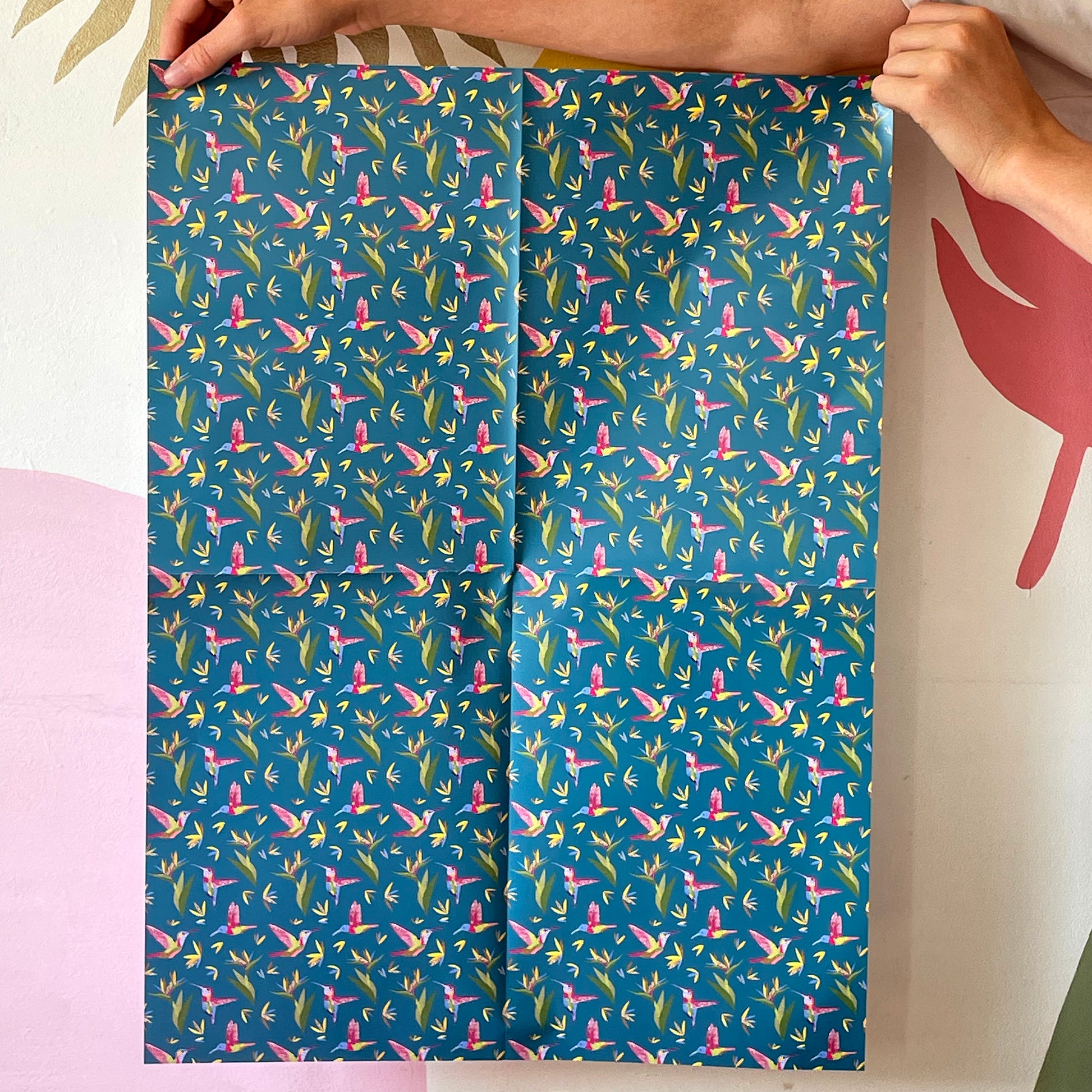 Image shows a beautiful bird paradise gift wrap featuring a stylish hummingbird and plant design.