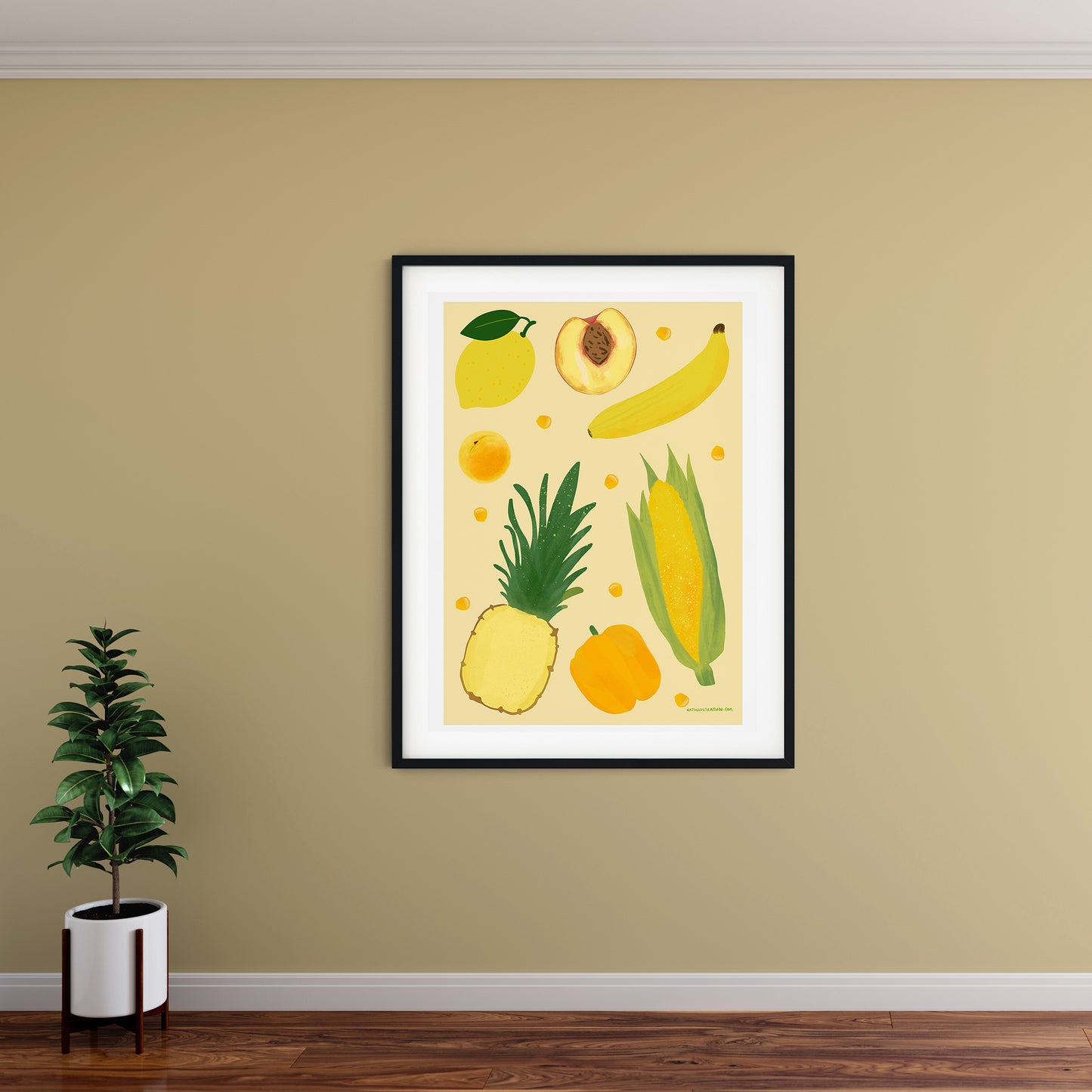 Image of a framed art print of yellow fruit and vegetables on a pale yellow background.