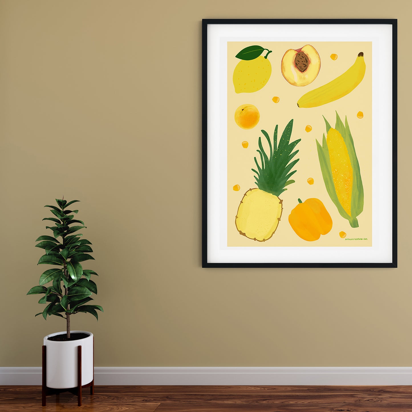 Image of a framed art print of yellow fruit and vegetables on a pale yellow background.