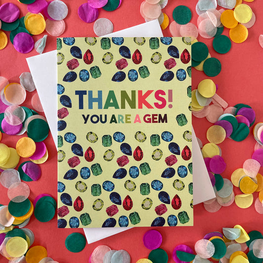 Image shows a light green greetings card with illustrations of gemstones and the words 'thanks you are a gem"