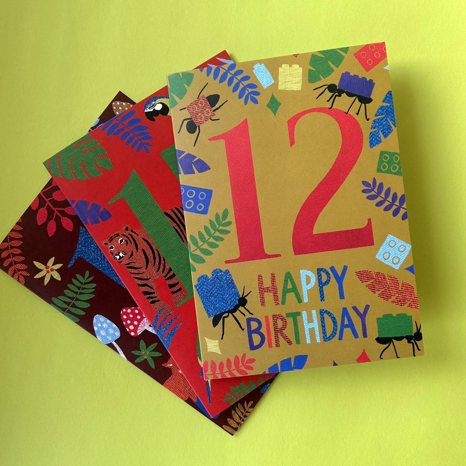 Three colourful birthday cards on a yellow background