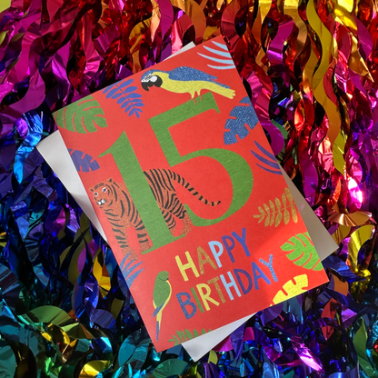 Birthday card with colourful animals and '15 Happy Birthday' text on a glittery background