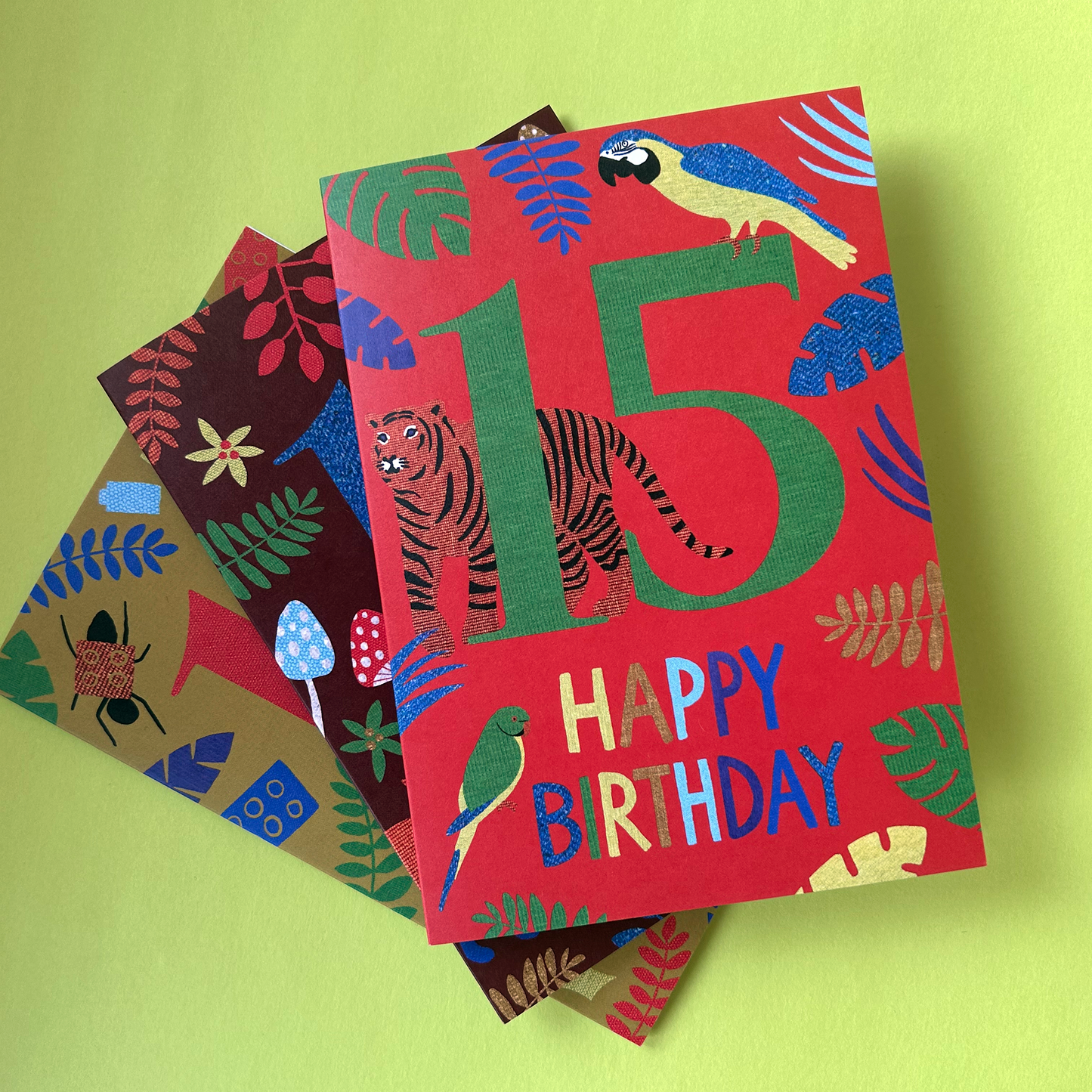 Colourful birthday card with animal designs on a green background