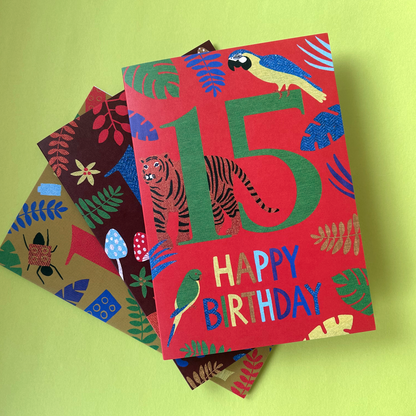 Colourful birthday card with animal designs on a green background