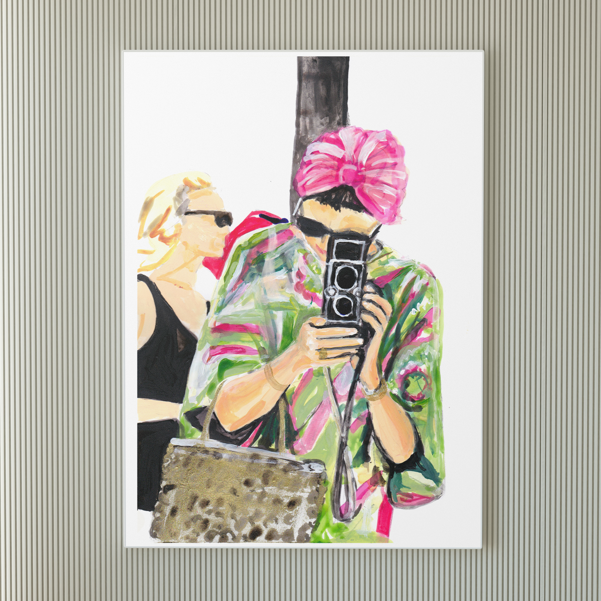 Image shows an illustration of a woman in a pink and green kaftan, black sunglasses and pink turban holding a vintage camera.