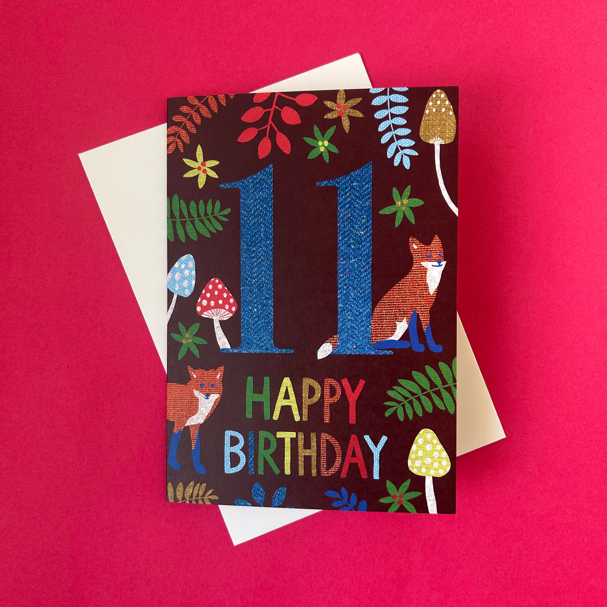 Birthday card with number 11 and fox illustration on a red background