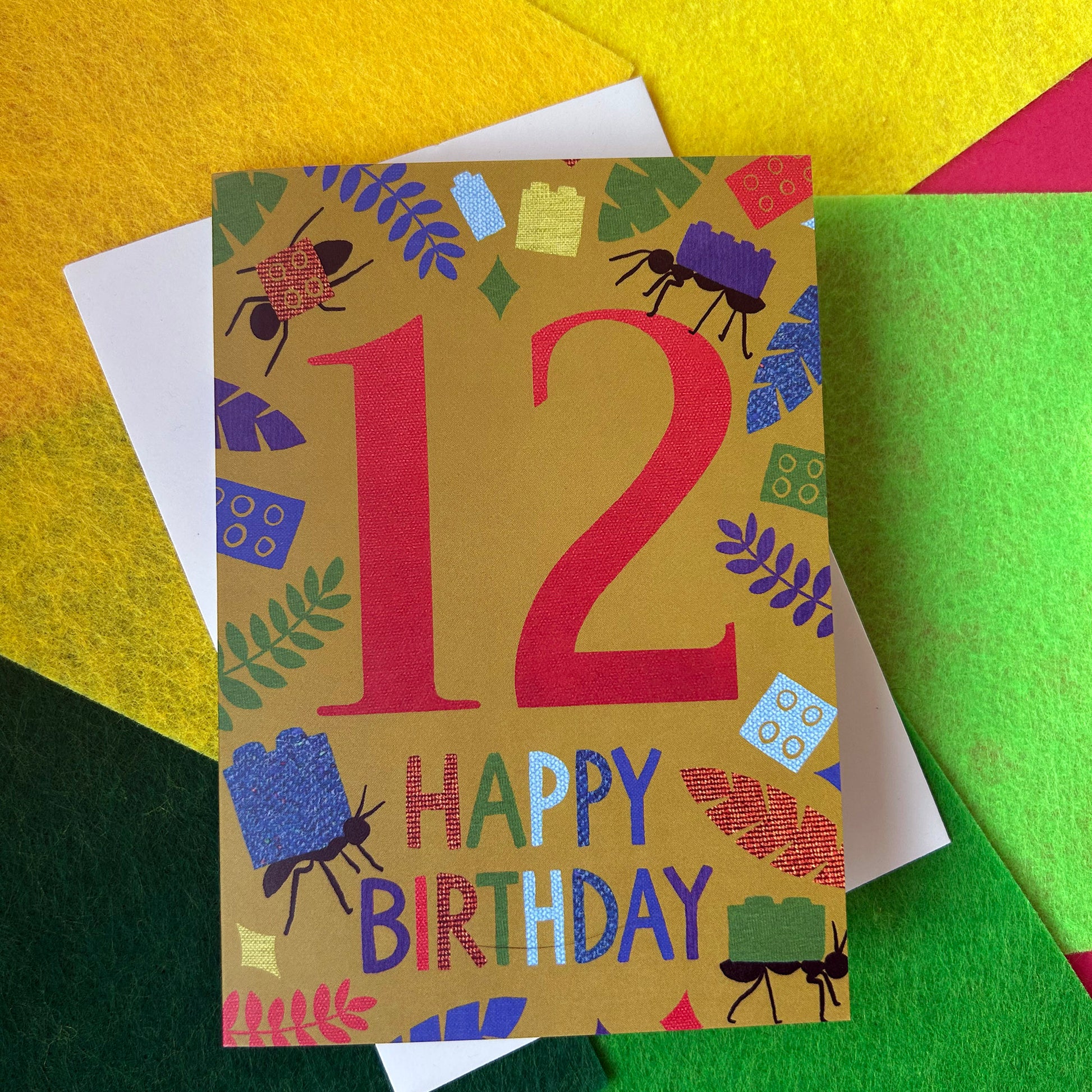 Colourful birthday card with number 12 and 'Happy Birthday' text on a textured surface.